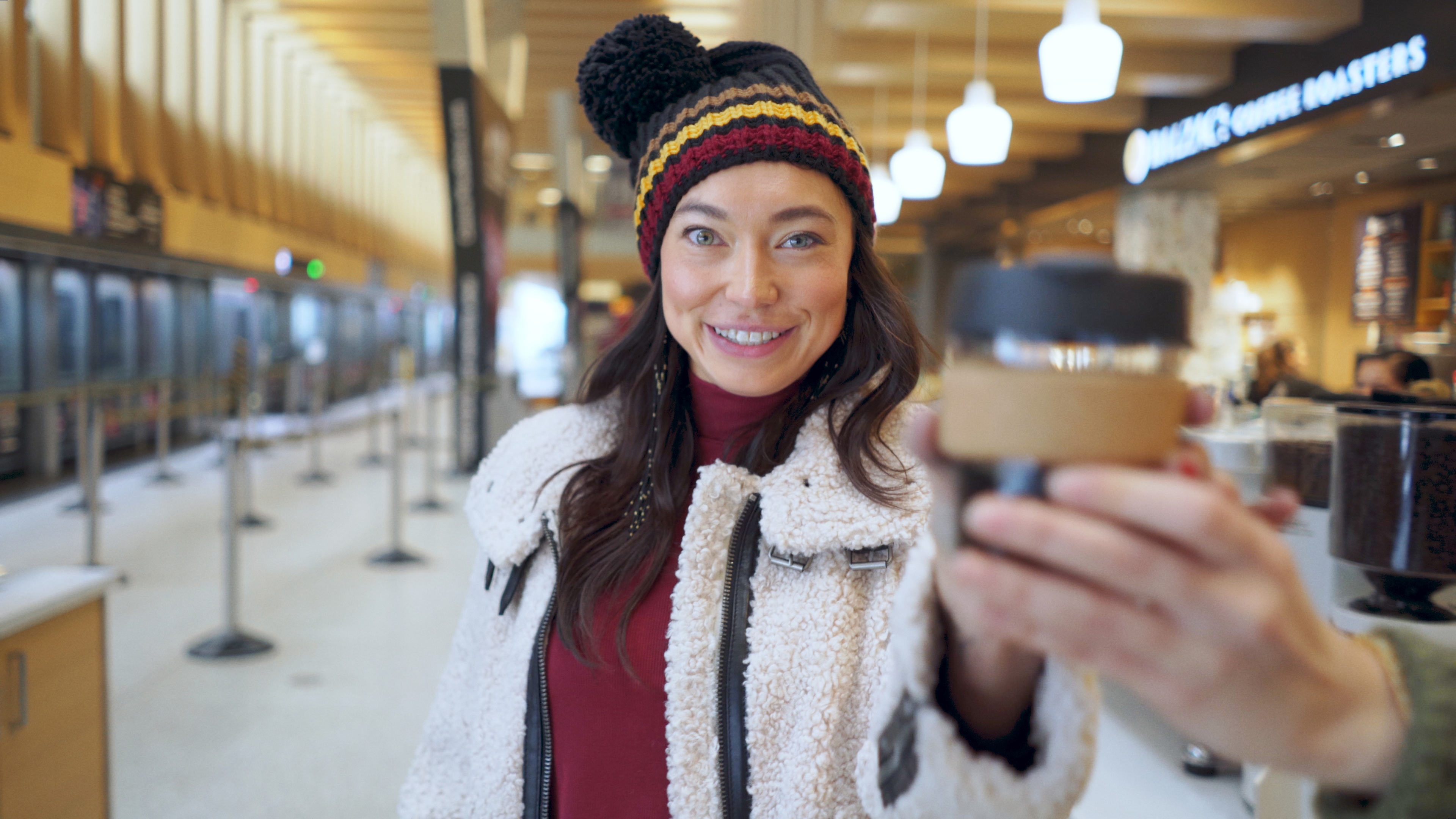 Front cover image for a short film made for TreadRight. The image shows a woman looking at the camera while being handed a coffee.