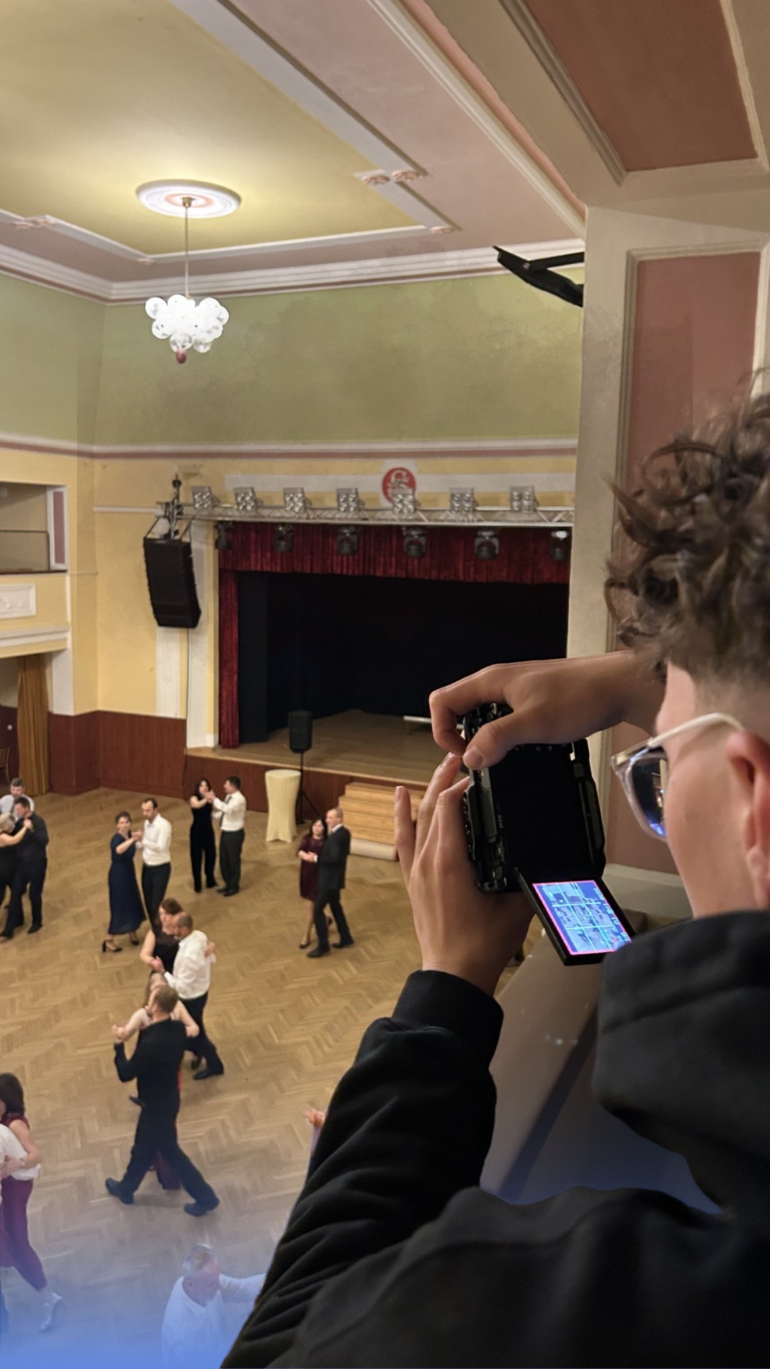 Young man in sage green button-up shirt and beige pants