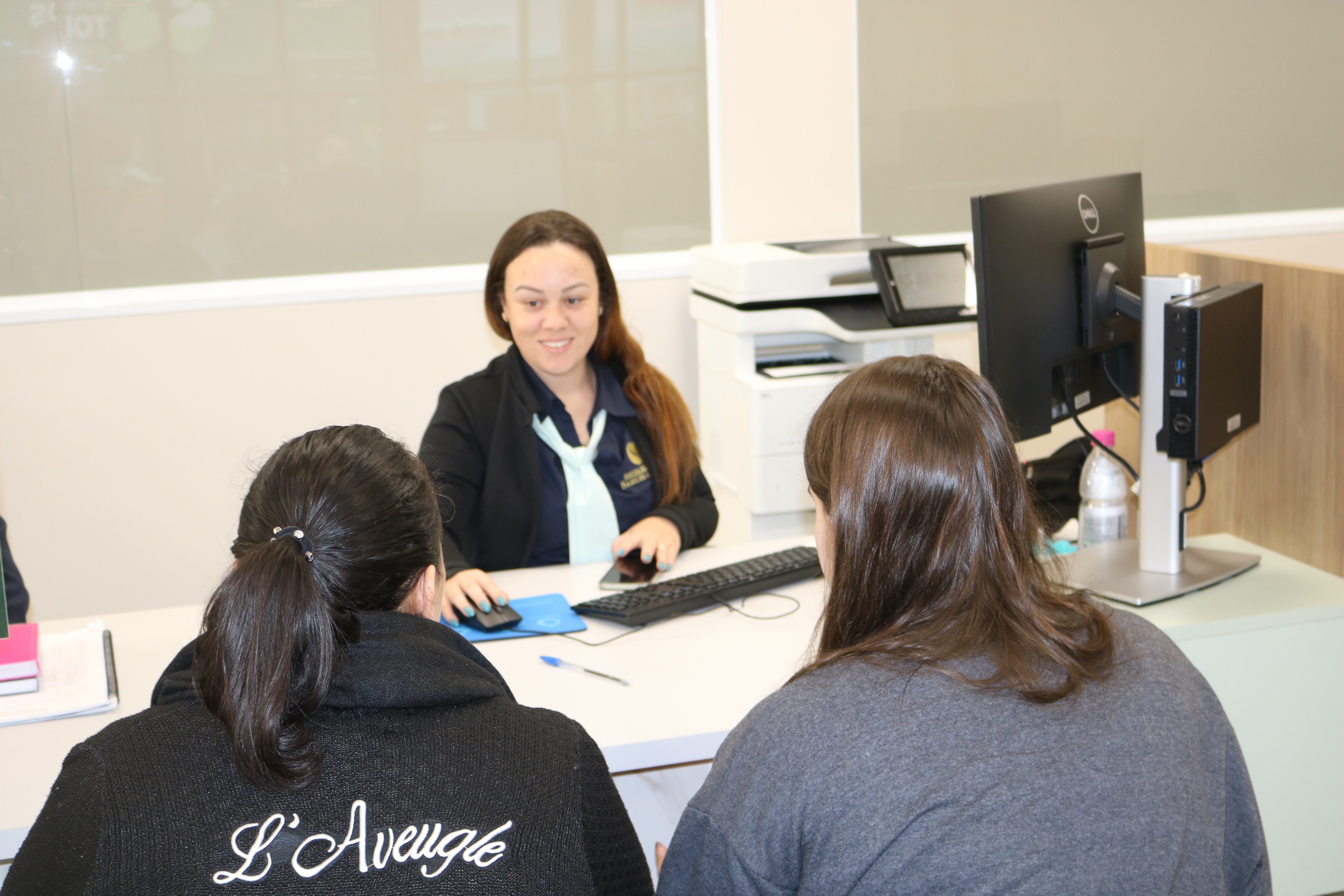 Doctor consulting with elderly man and child.