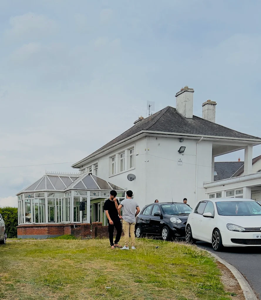man in black crew neck t-shirt and blue shorts holding woman in white and red