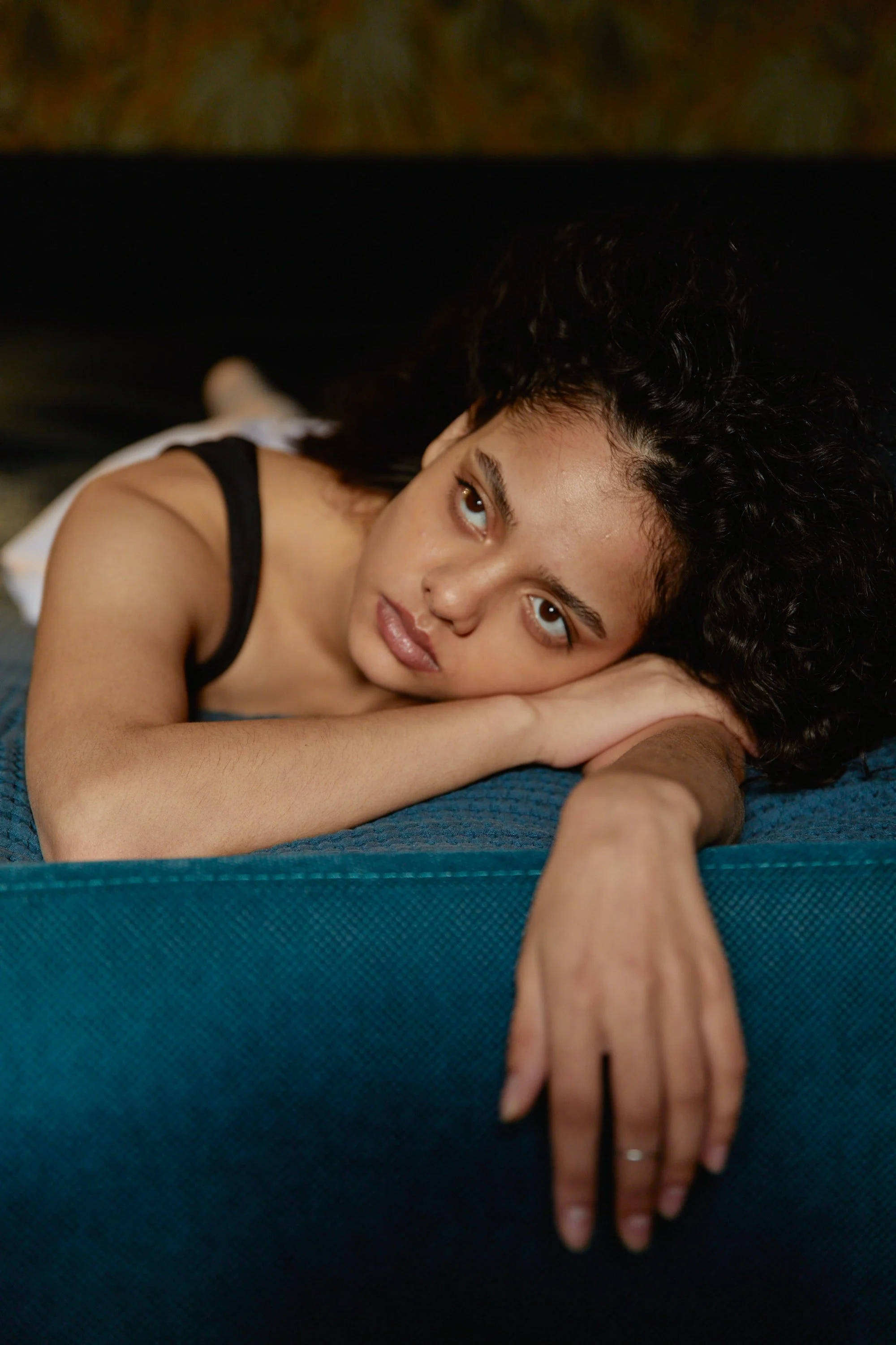 A woman lying down and looking into the distance
