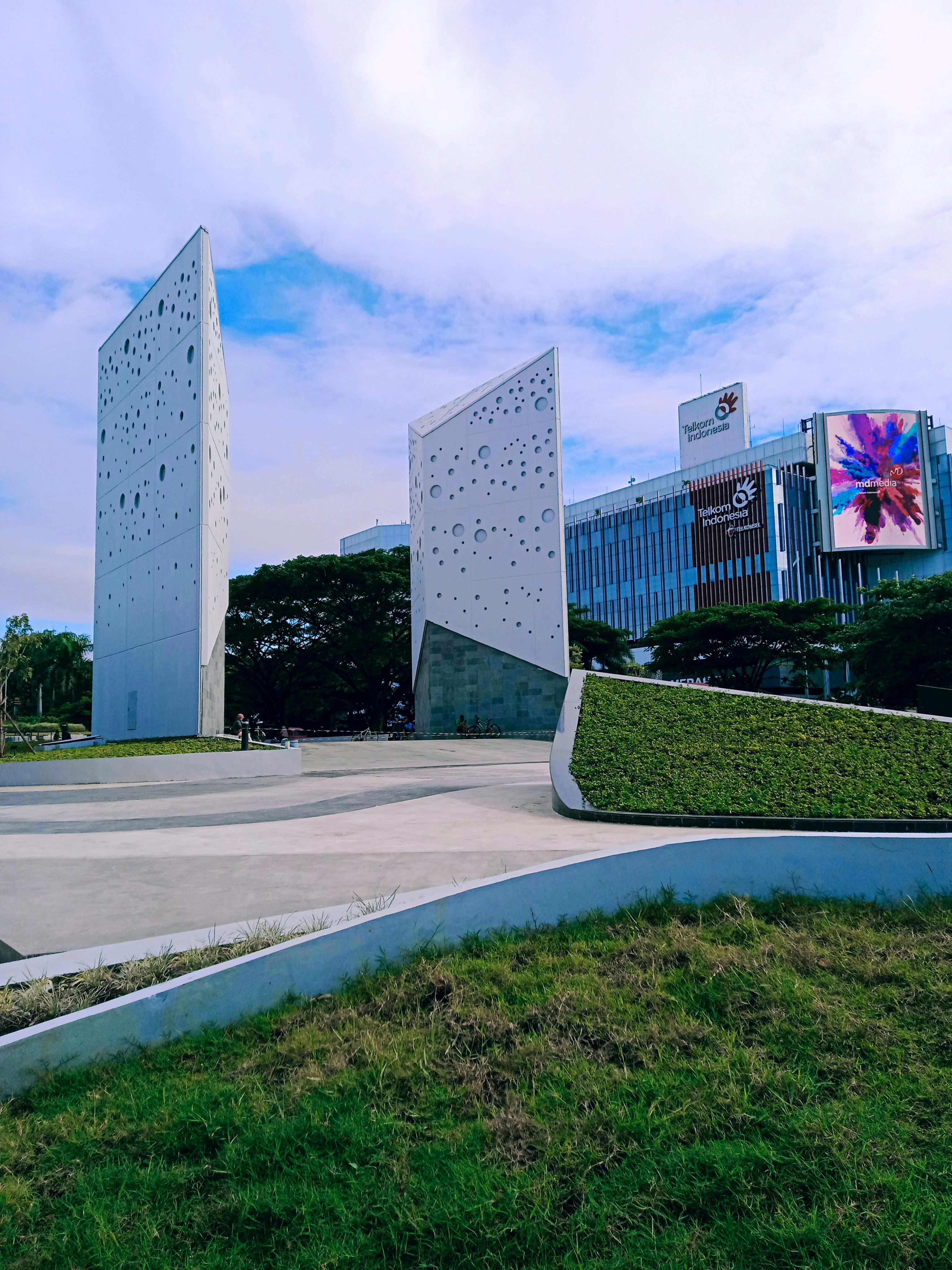 a grassy area with a building in the background