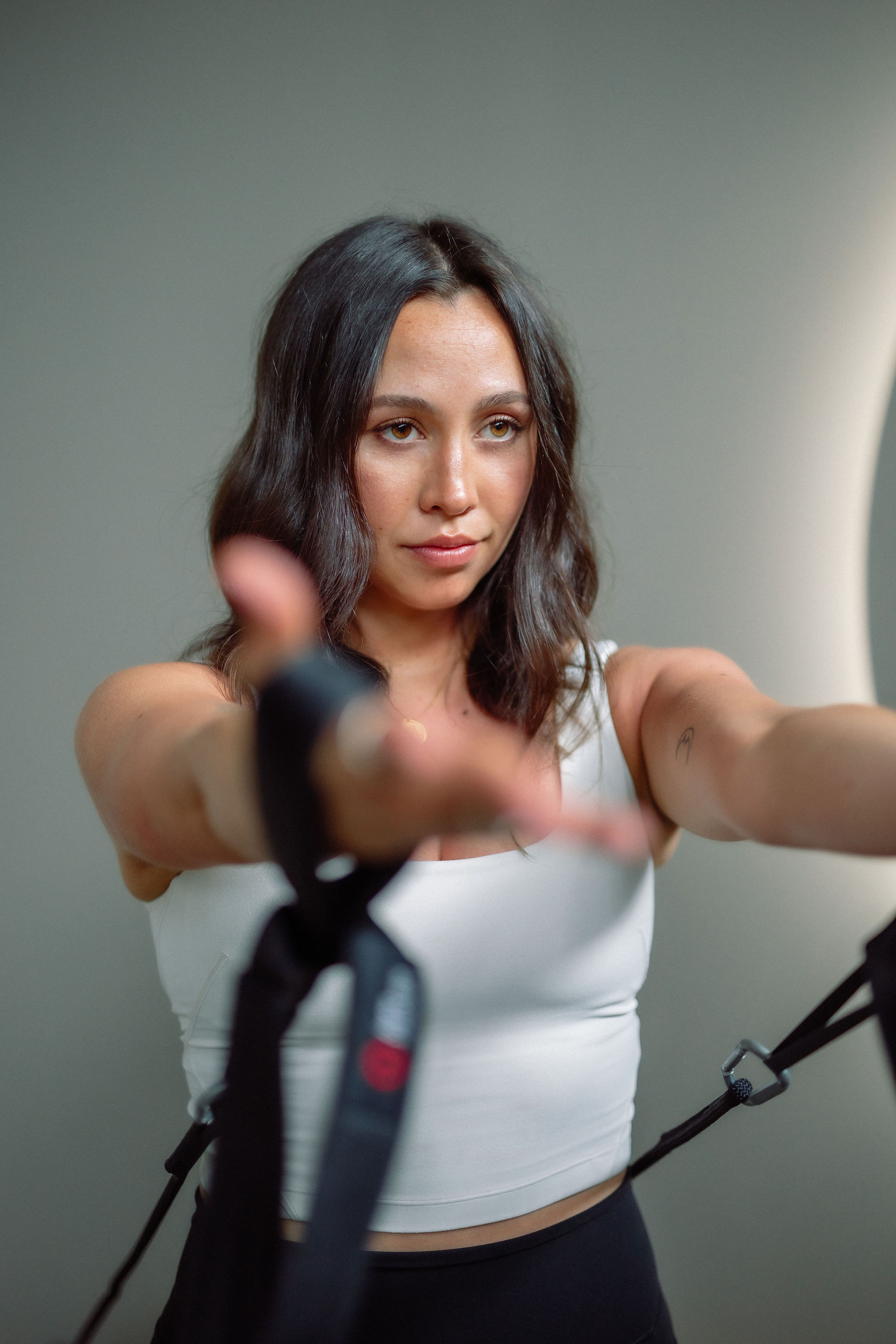 Black cosmetic product bottle against a dark background