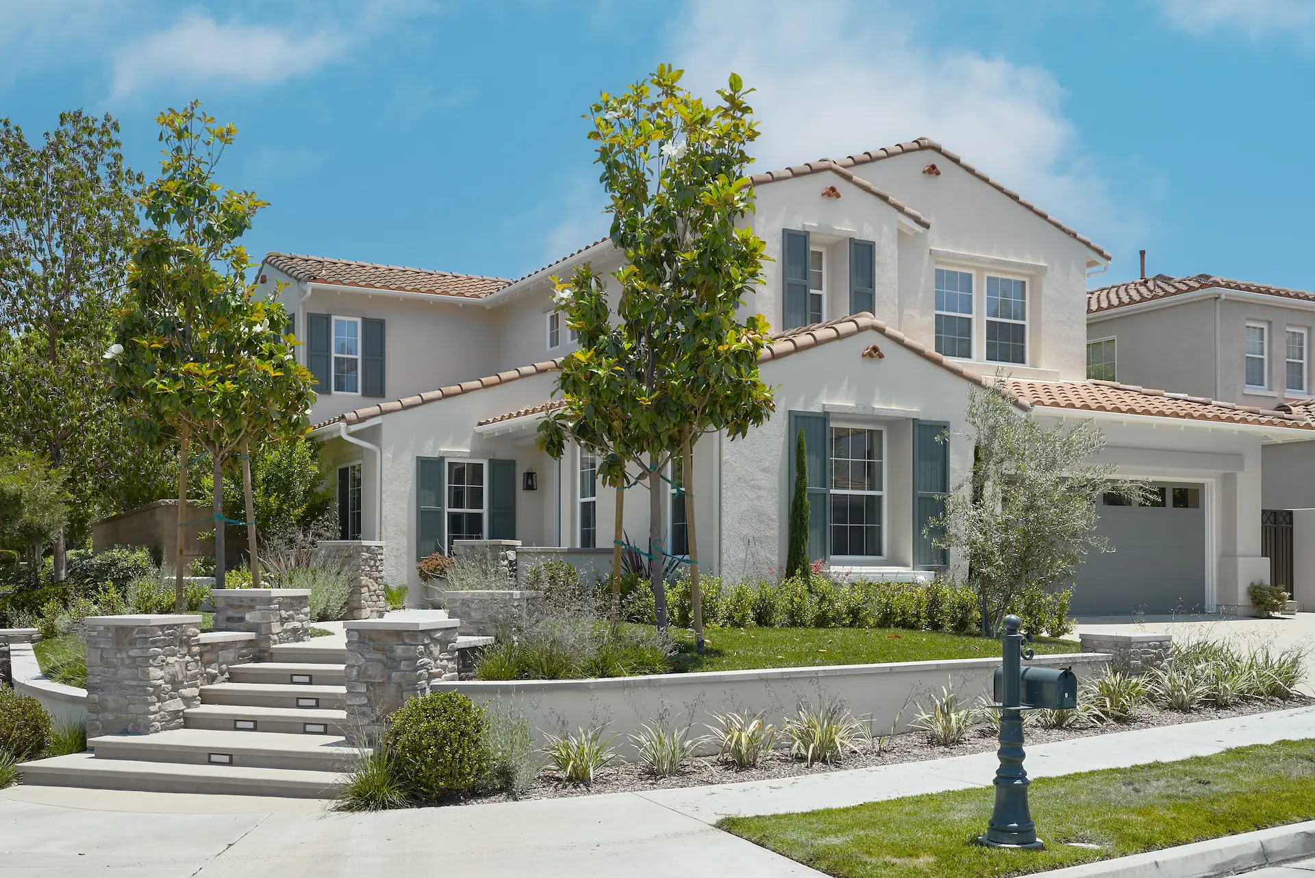 Street view of the exterior front of the Irvine Contemporary Coastal Remodel, showcasing the home's facade and landscaping. Photo by Todd Huge.