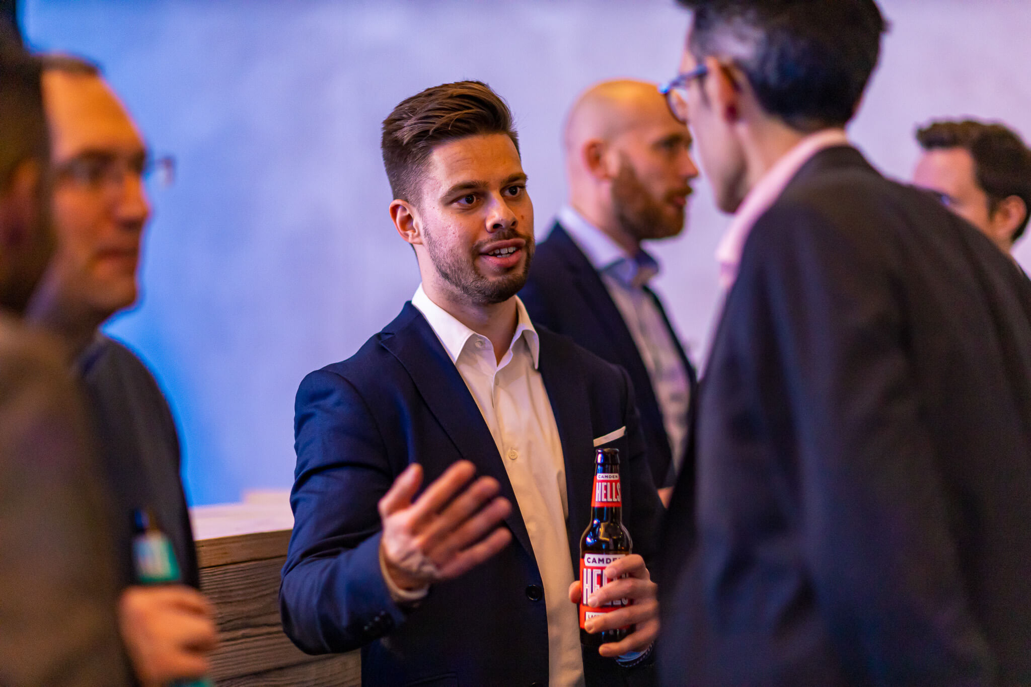 Candid moment of guests in conversation during a corporate social event