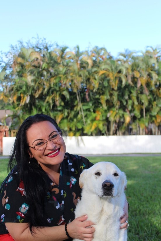 anna posing with a white lab and shepard mix outside