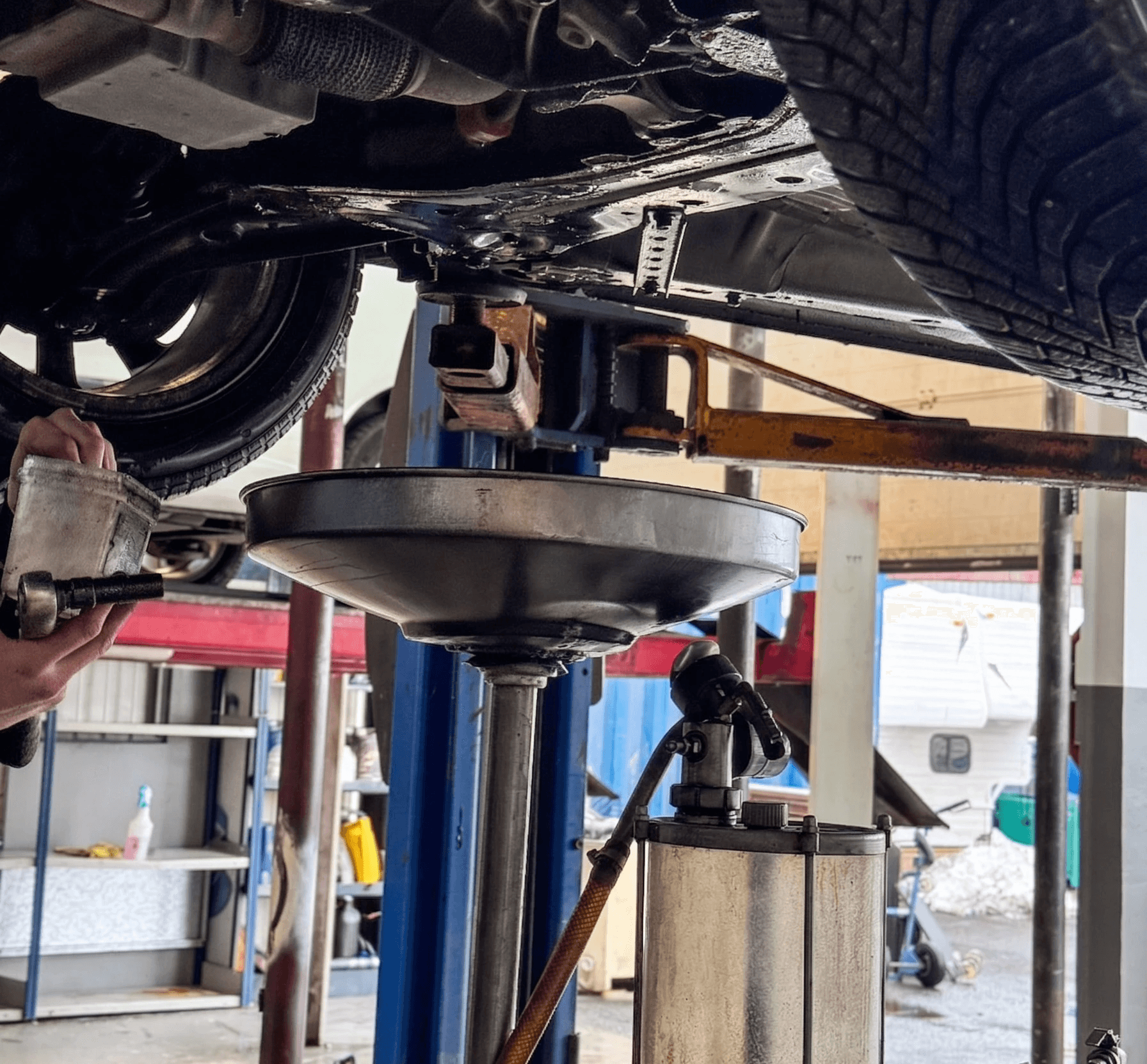 a man working on a tire in a garage