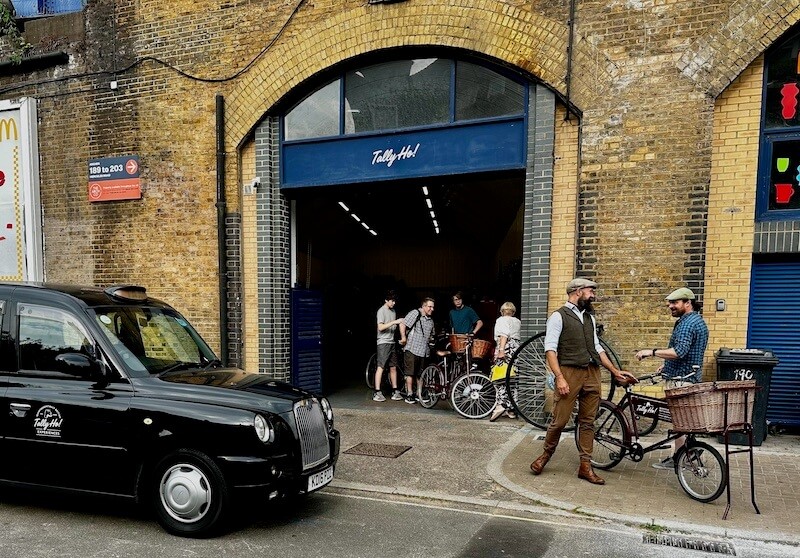 A group ready for a bicycle tour of London at the Tally Ho bike tour meeting point