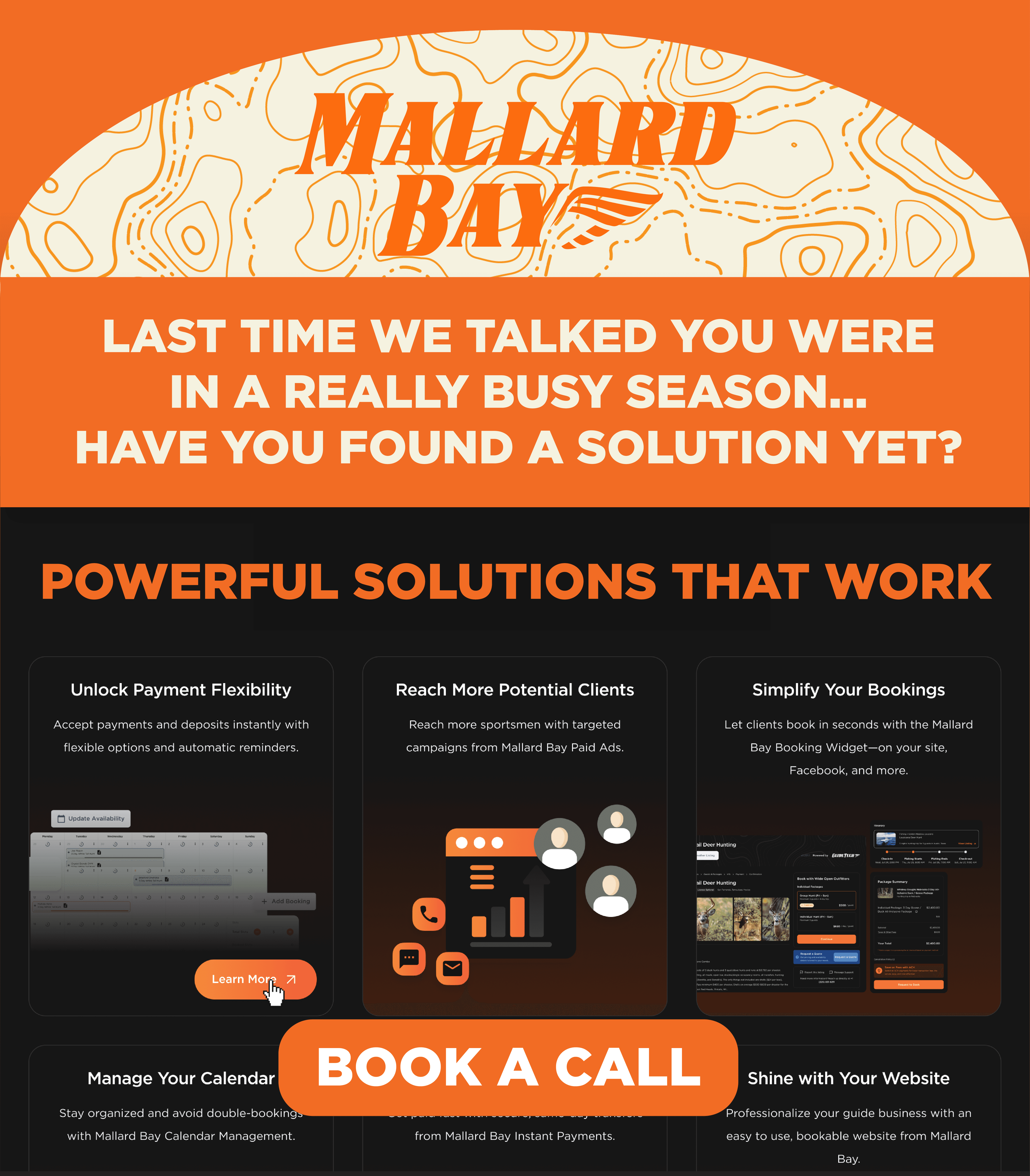 Black and white photo of two people looking at a computer screen with papers on wall