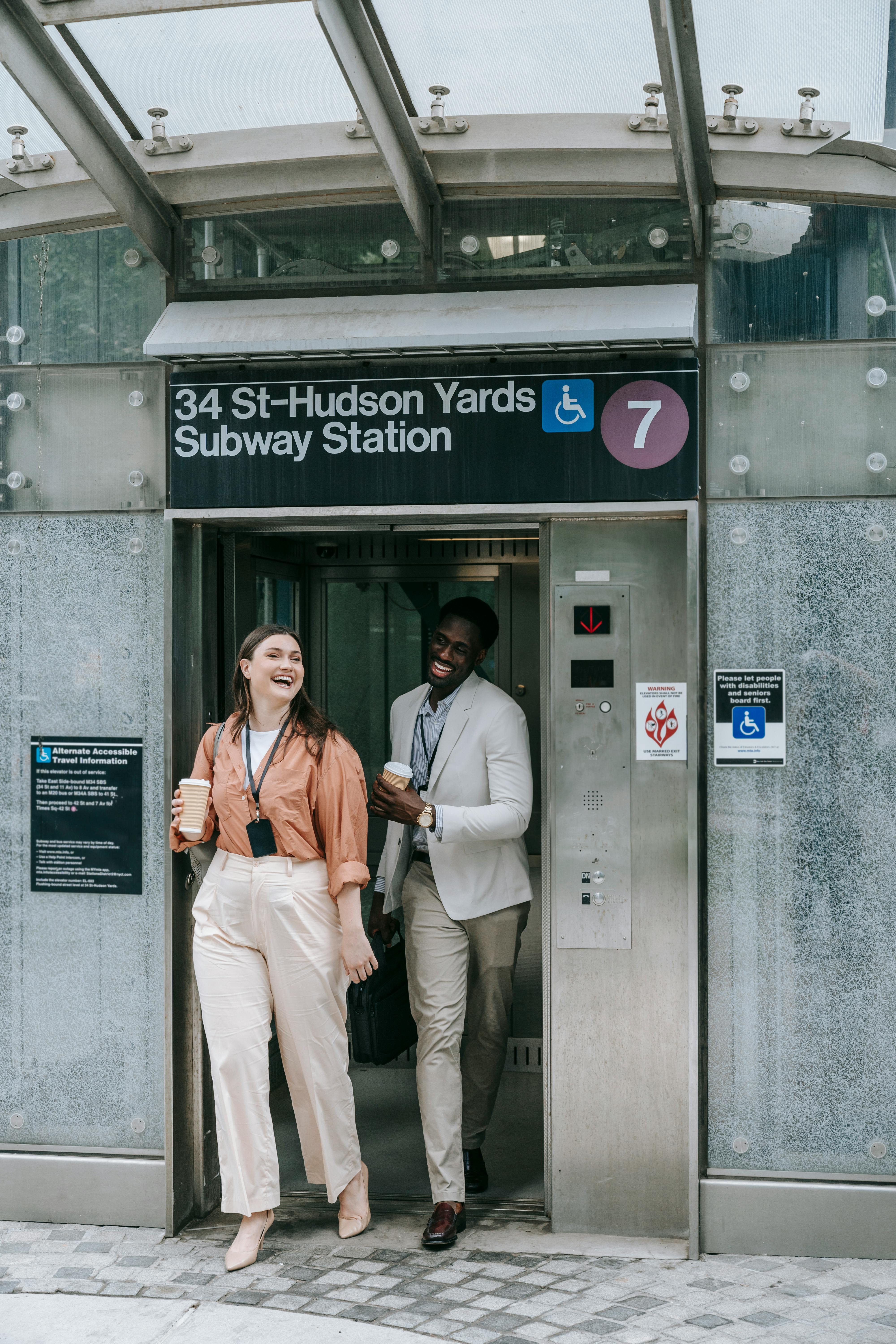 Two people standing at subway station entrance