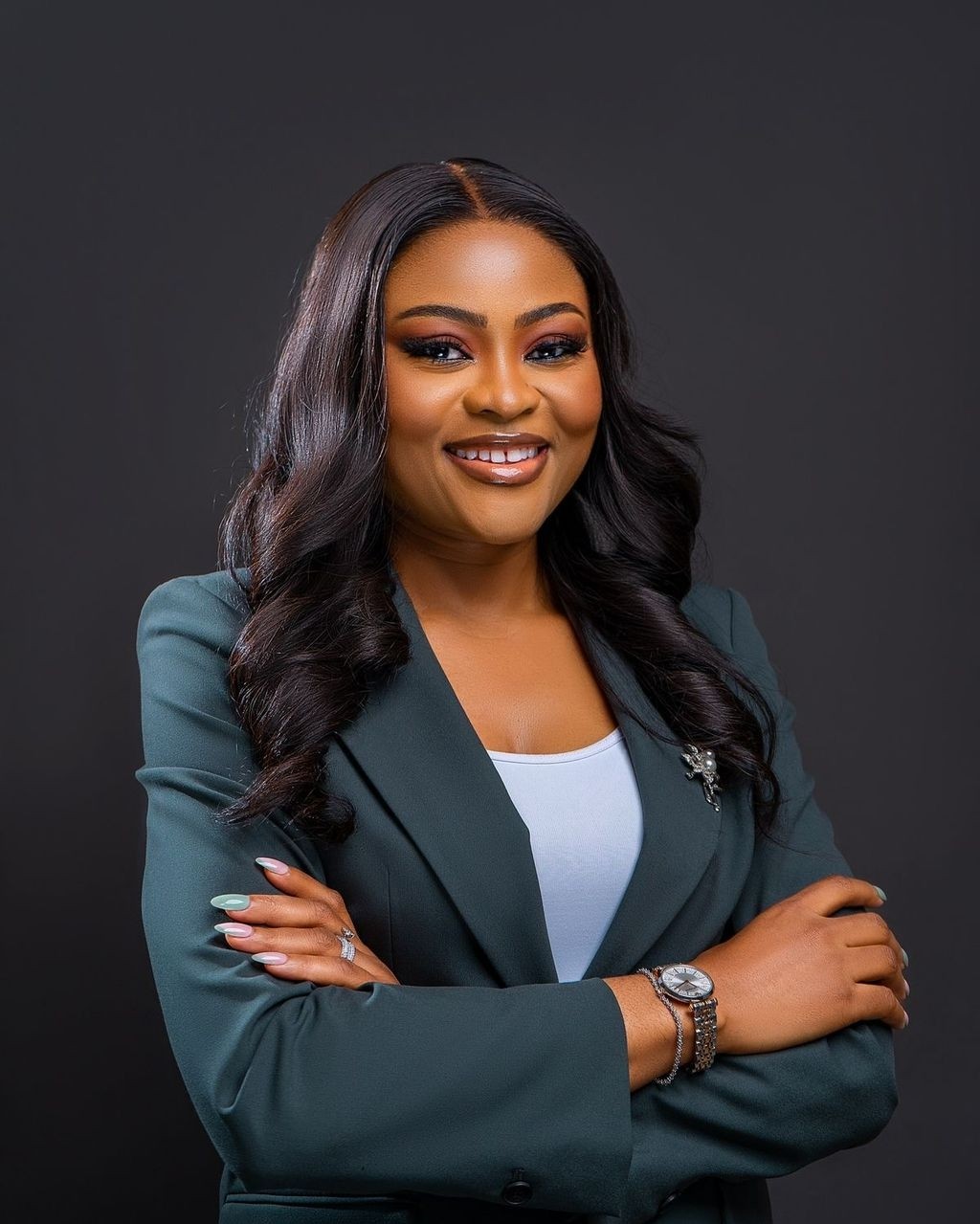 Close-up portrait of a freckled woman with soft pink hair and star earring, natural light, white tank top.