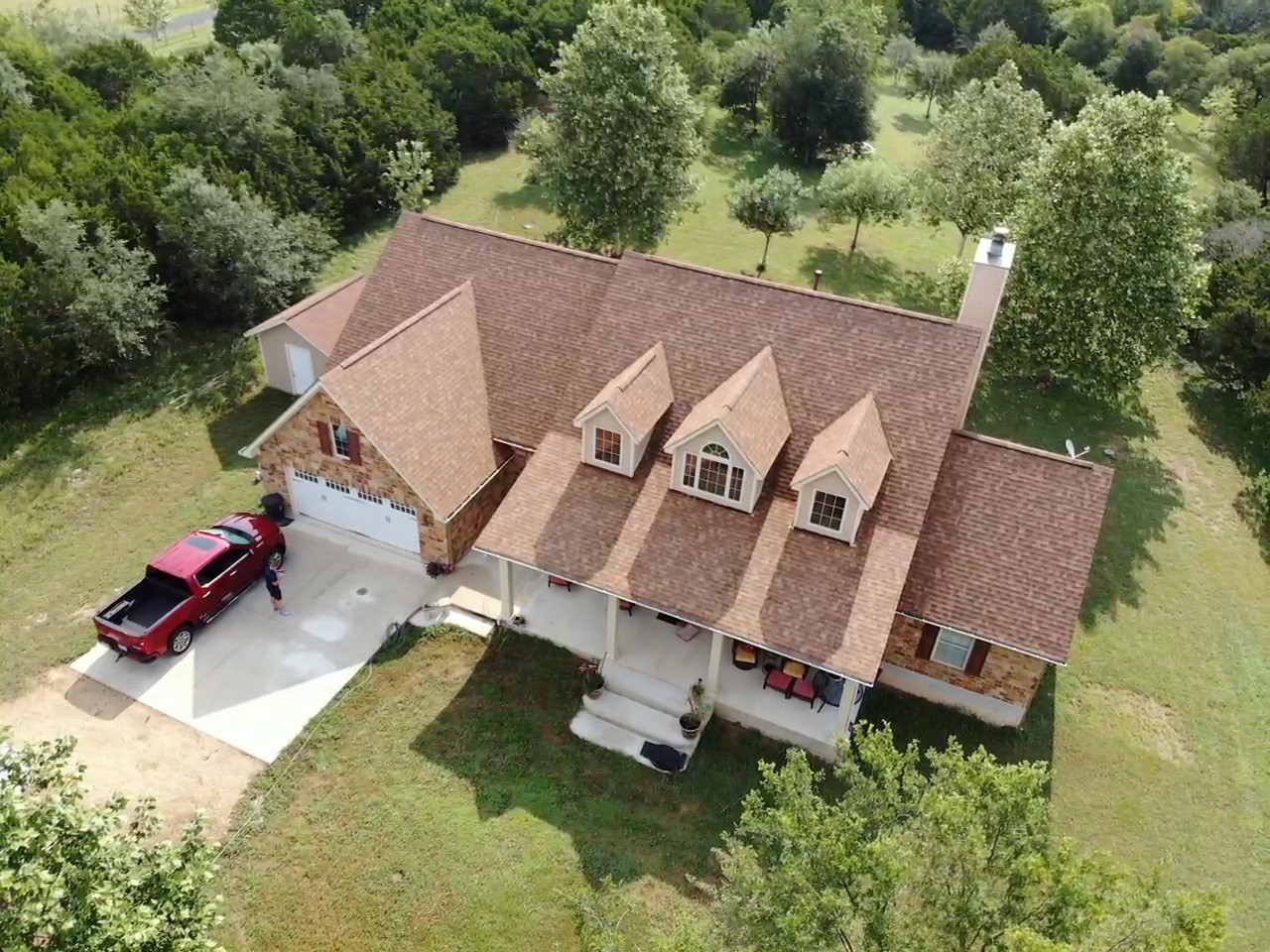 GAF Timberline HDZ Shakewood shingle roof with elegant dormers on a charming country home in San Antonio, expertly installed by Barnes N' Roofs.