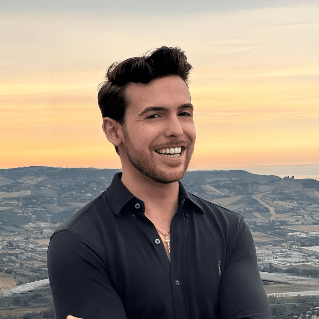 A man works on a laptop in an office.