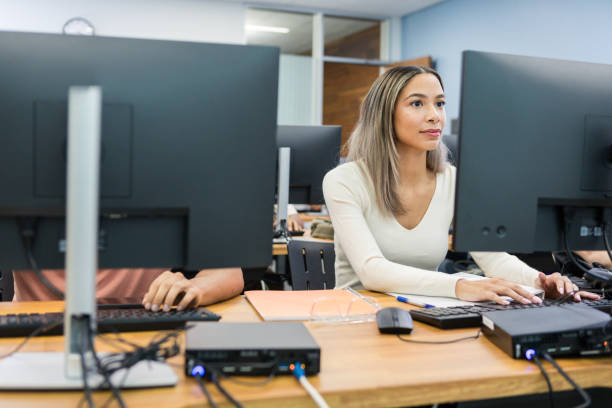 woman working in an office looking at a desktop monitor