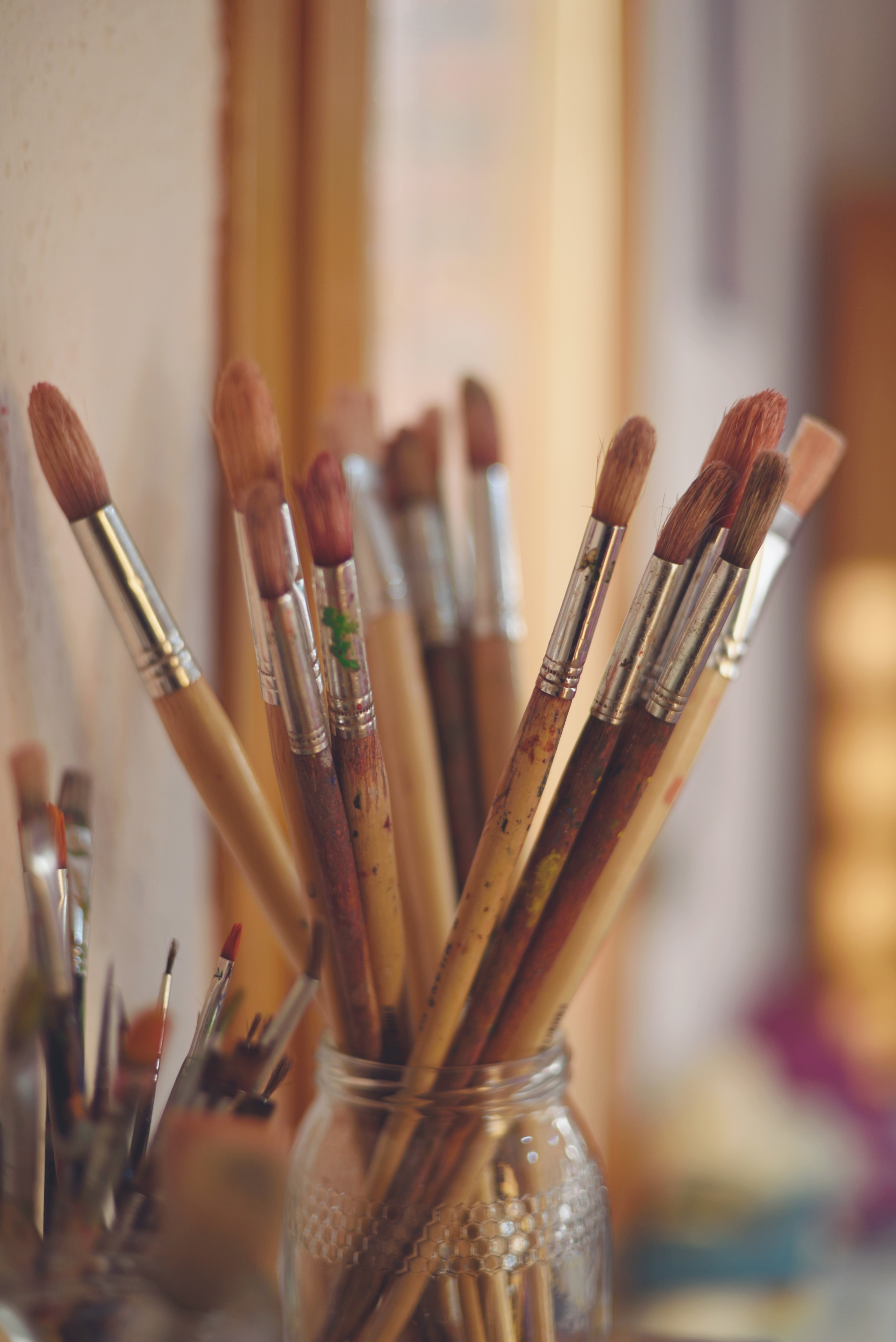 Close-up of a dark green leaf showing its textured surface and central vein against a muted background.