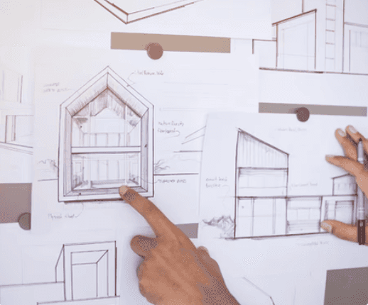 Construction workers review plans on site.