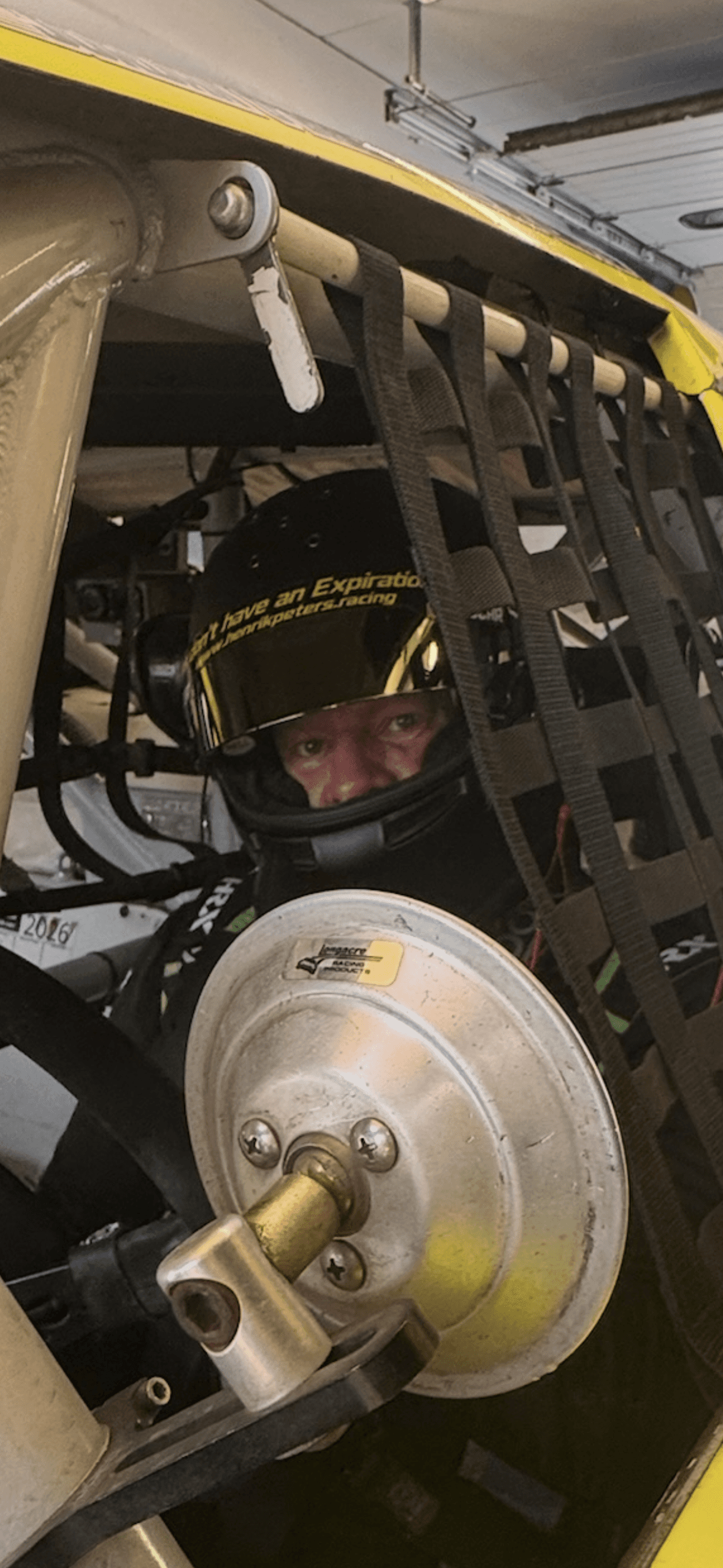 Henrik Peters close-up through the cockpit window net at Vallelunga