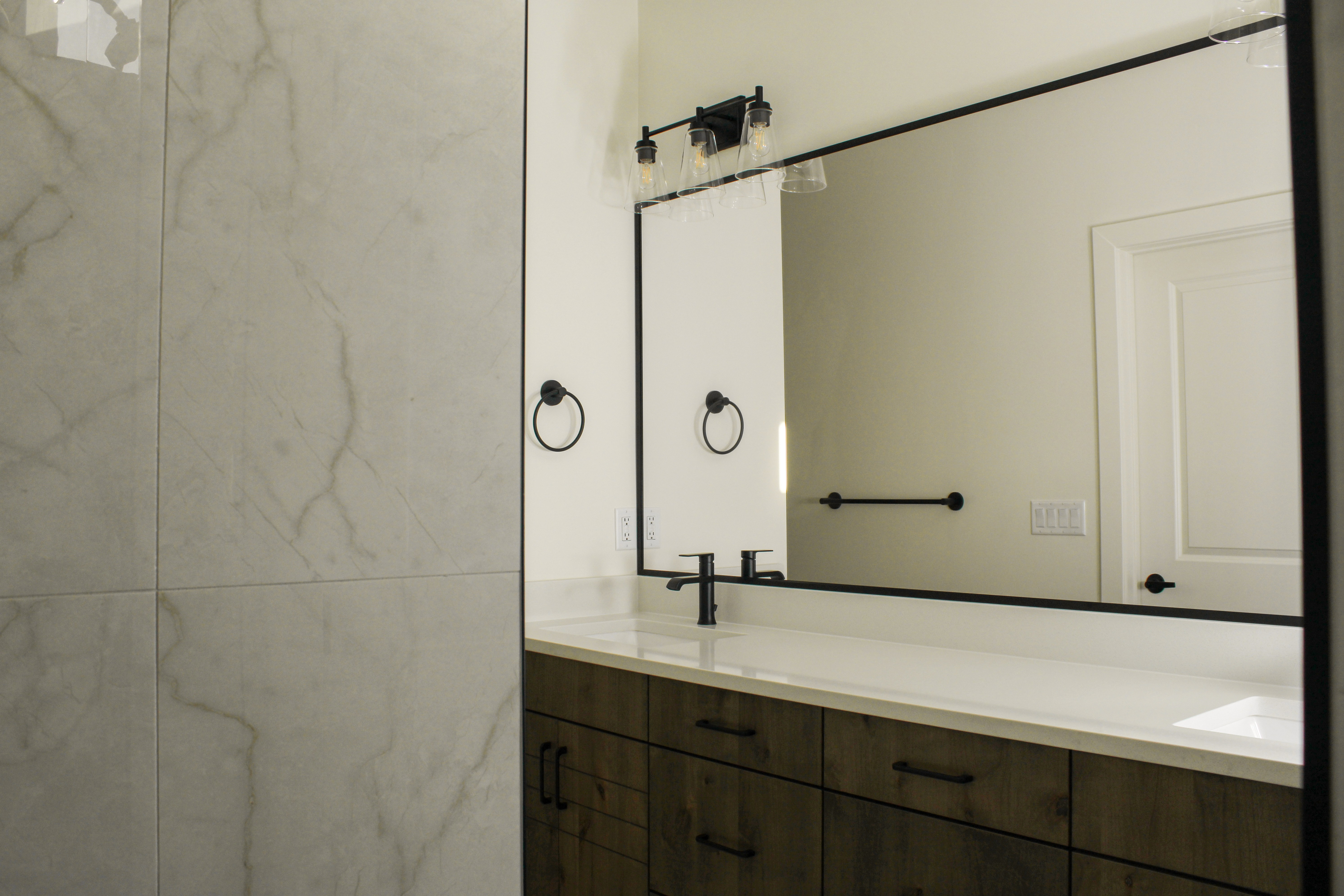 Primary bathroom vanity inside the Golden Hour home in Hurricane, Utah featuring a spacious vanity and modern fixtures.
