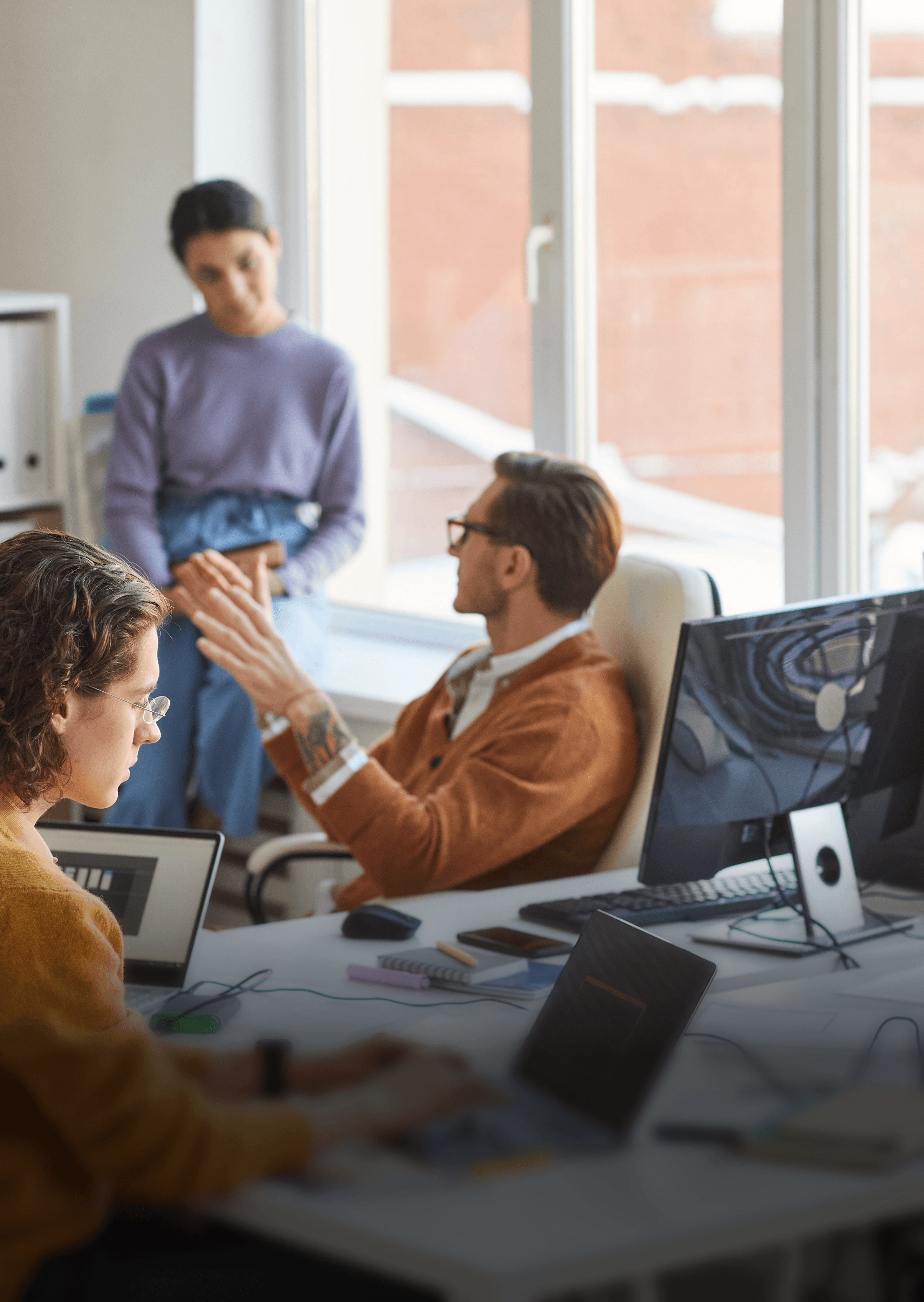 photo of three people working at a saas agency having a meeting 
