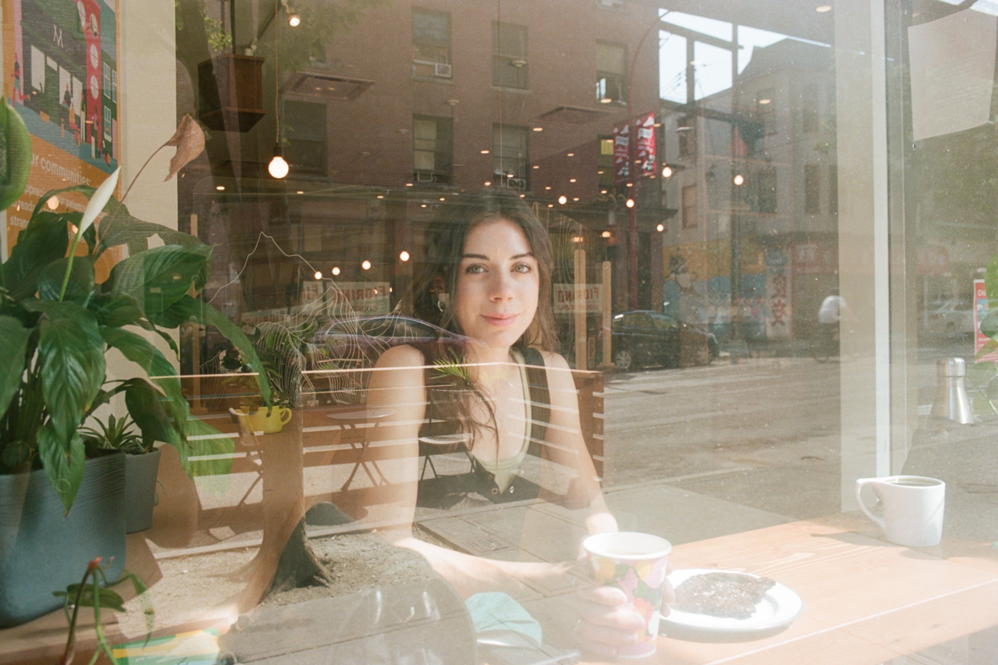 A close-up of a hand wearing multiple decorative rings against a blue background.