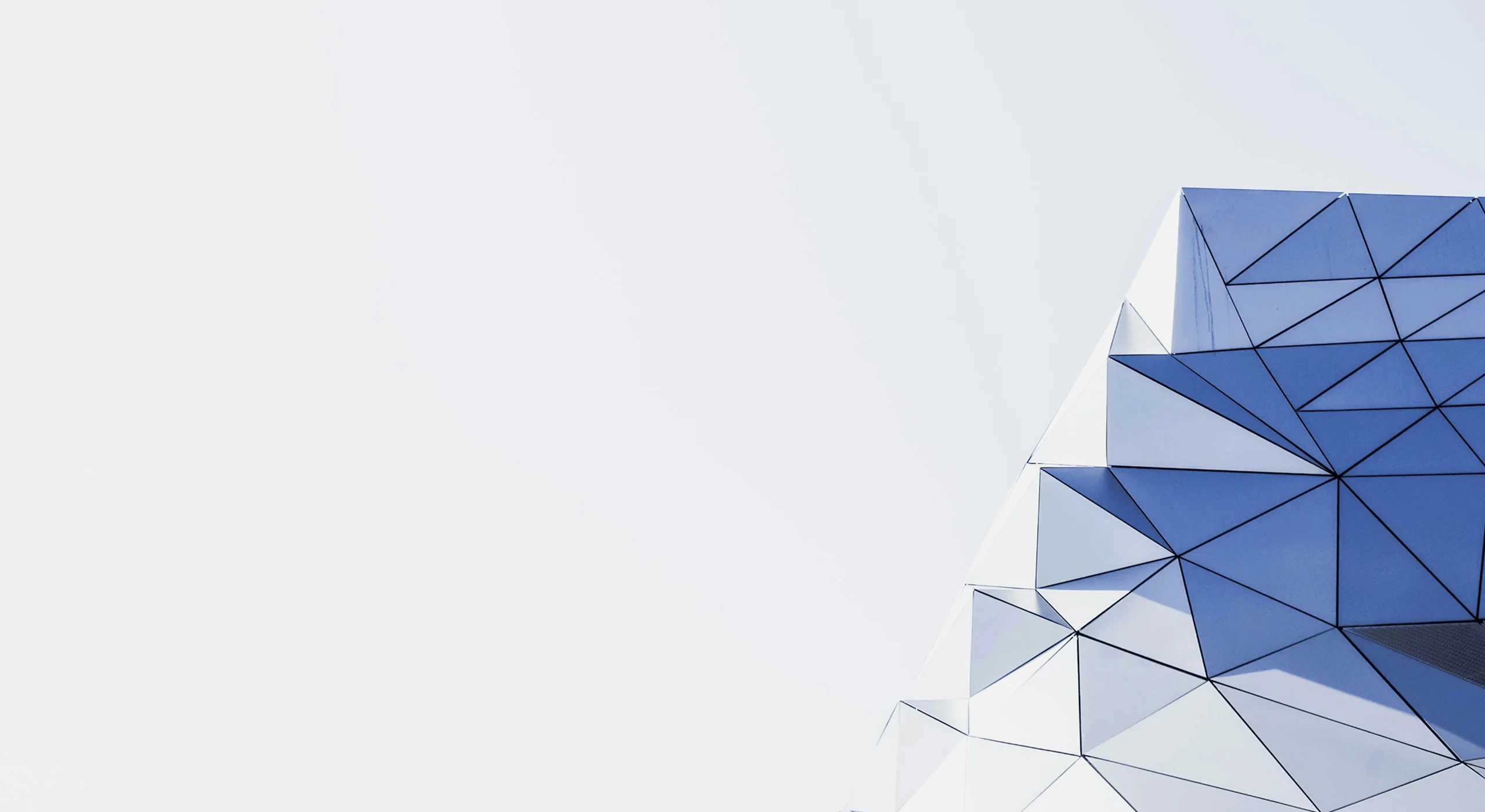 Close-up of a geometric glass prism facade.