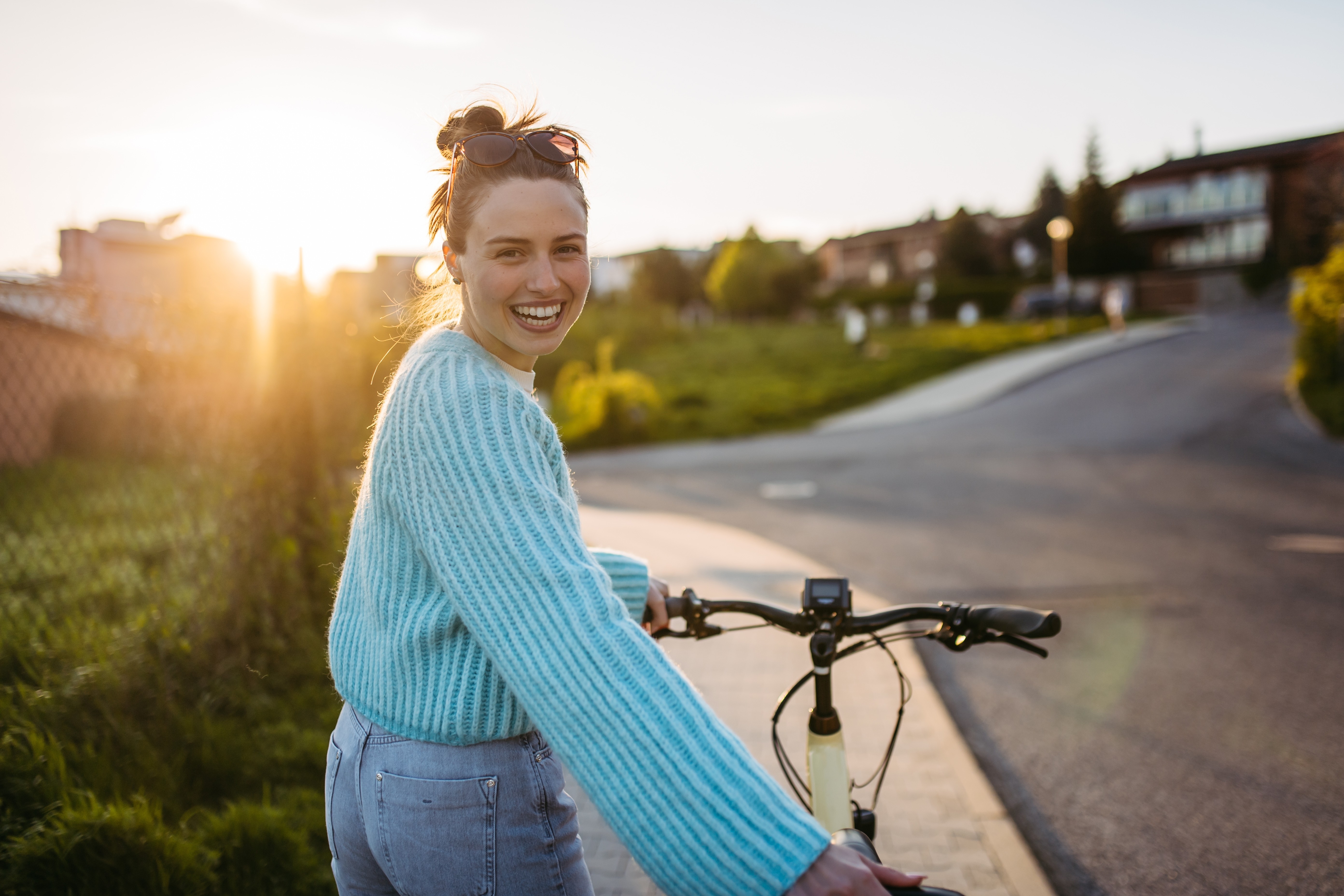 smiling woman walking with e-bike