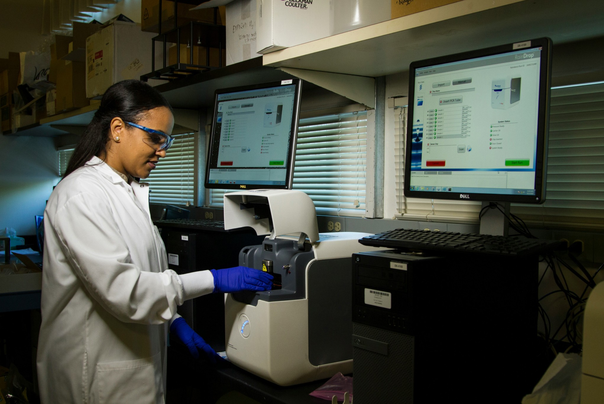 Laboratory technician operating medical equipment, illustrating financial challenges in healthcare such as the high cost of advanced technology and lab operations.