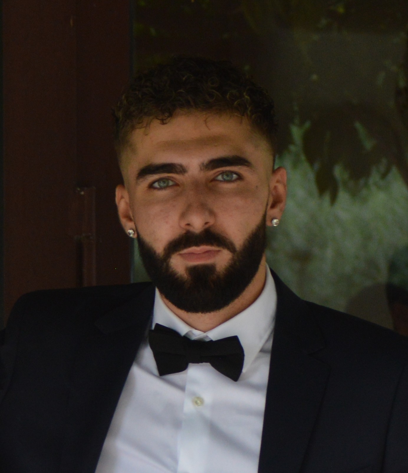 a woman in a black suit and sunglasses