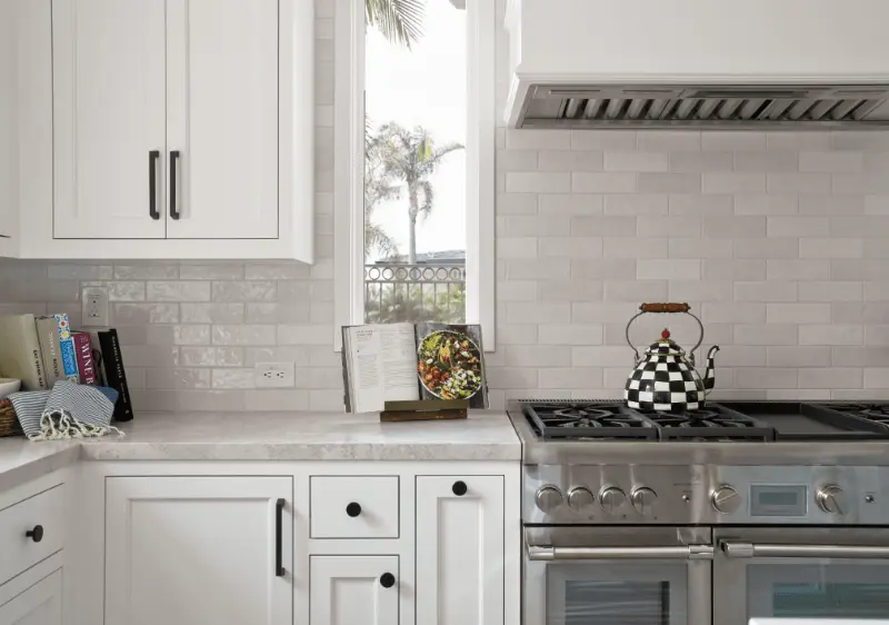 Close-up view of the stove and backsplash, showcasing the design and details in the Dana Point Remodel. Photo by Todd Huge.