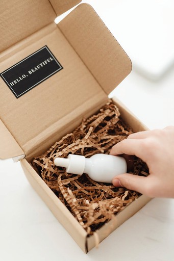 White bottle being placed in a decorative box