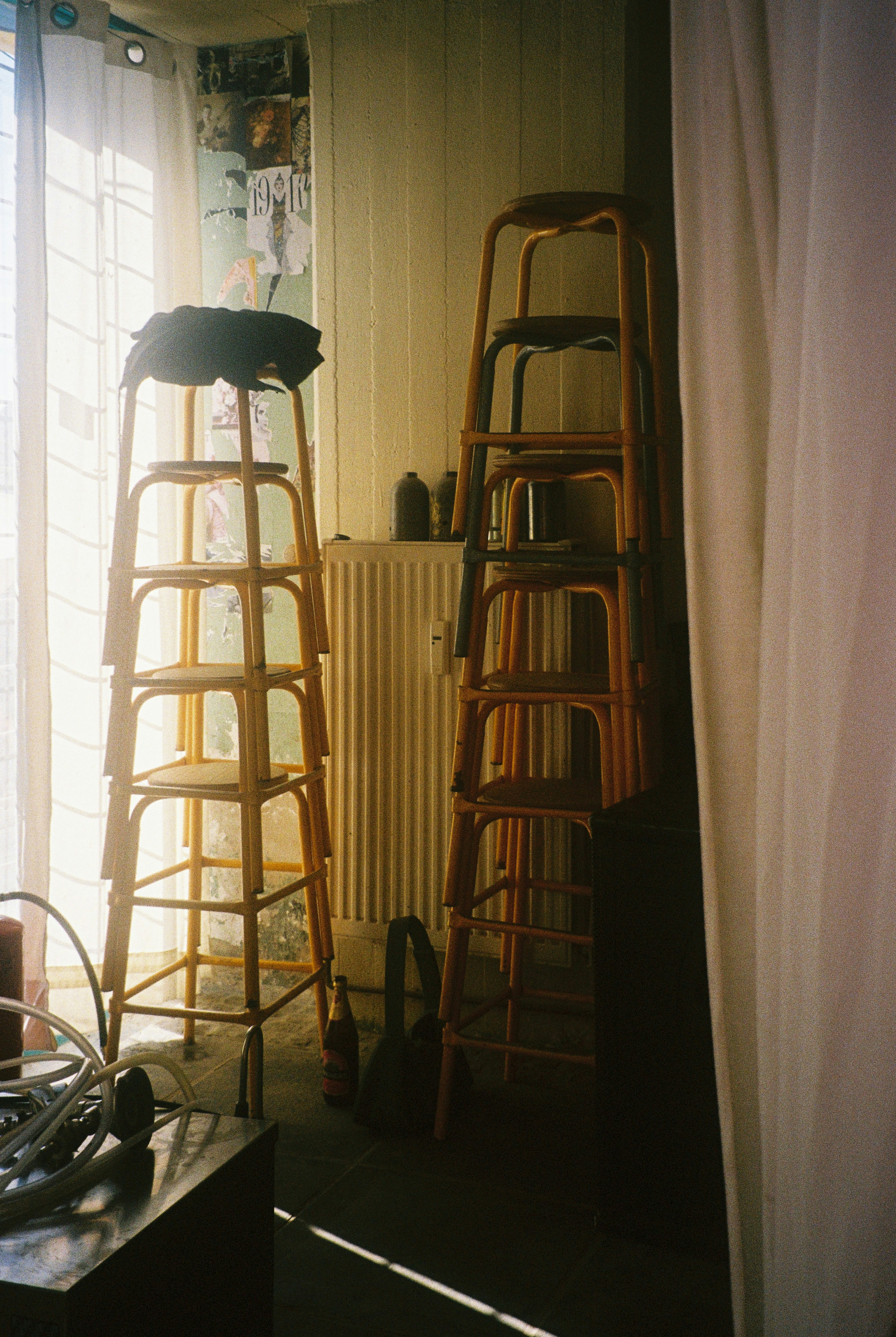Stack of wooden stools near a window
