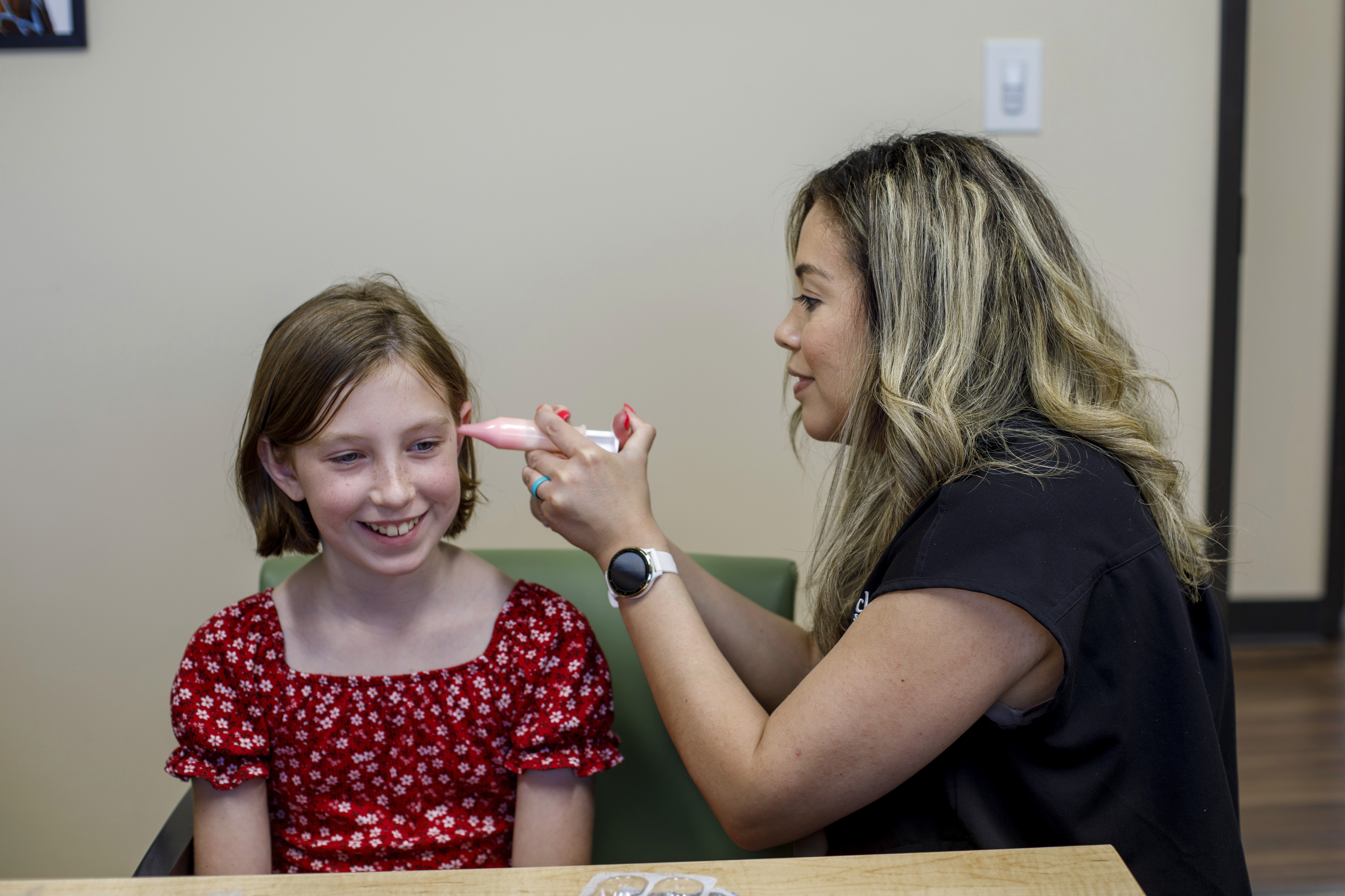 Dr Kelly Garcie taking an earmold of a young patient