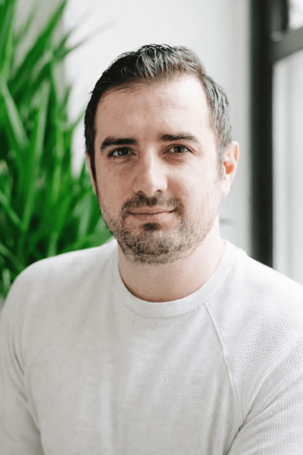 Black and white portrait of a smiling person with curly hair