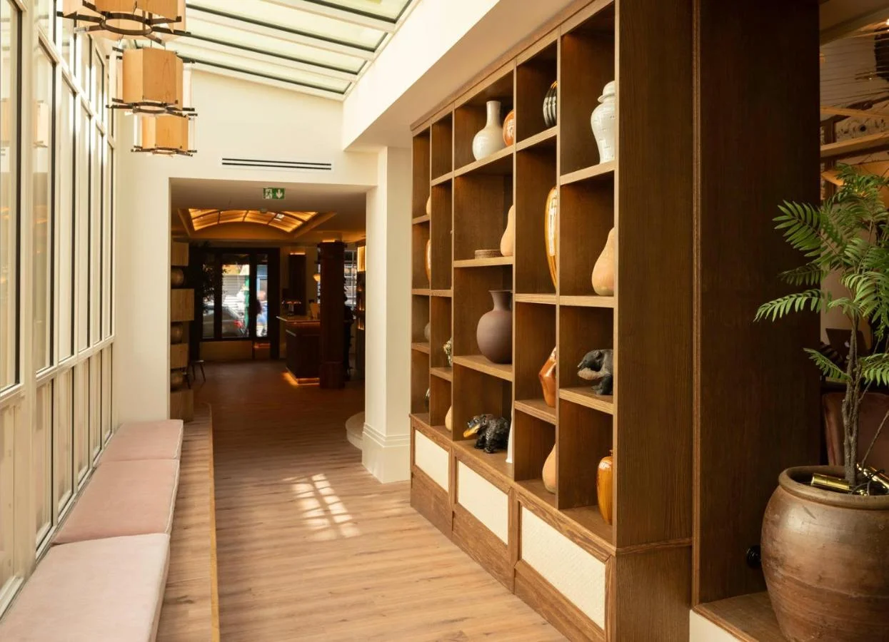 Golden cross atop a domed building with blue sky.