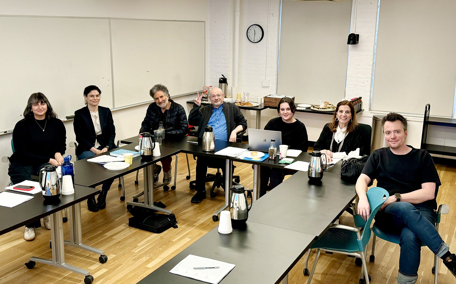 a group of people in a group shot in a classroom