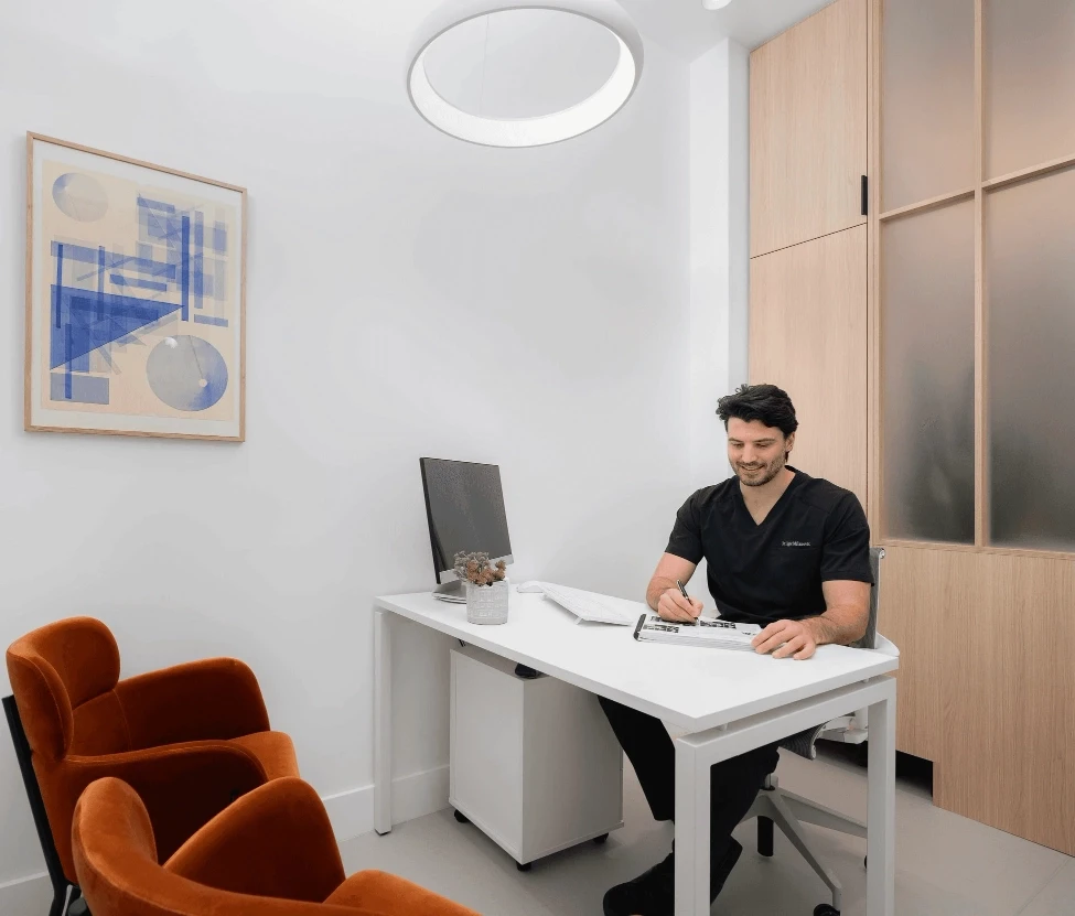 Dr. Igor Milanovic at dental consultation desk making treatment notes at Sovrle Dental Clinic in North York, Ontario: the best dentist in North York, Ontario