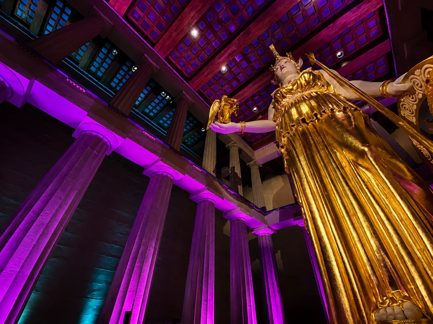 The Parthenon's gold Athena statue and columns lit purple for the Dan + Shay private concert, Nashville — event lighting by UpLight Technologies