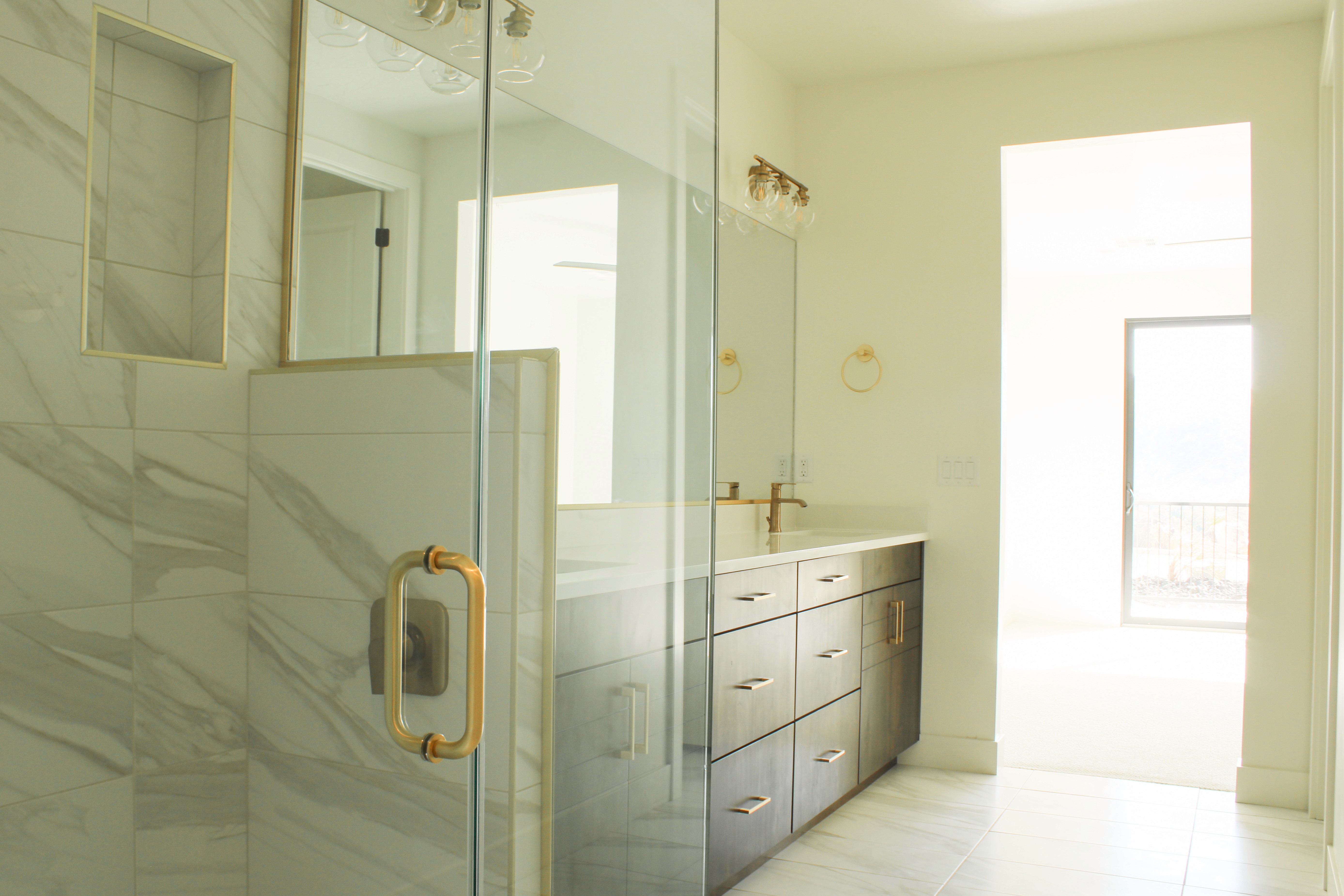 Master bathroom in The Overlook at Falcon Ridge custom home in Hurricane, Utah, showcasing tiled shower, modern fixtures, and luxury finishes.