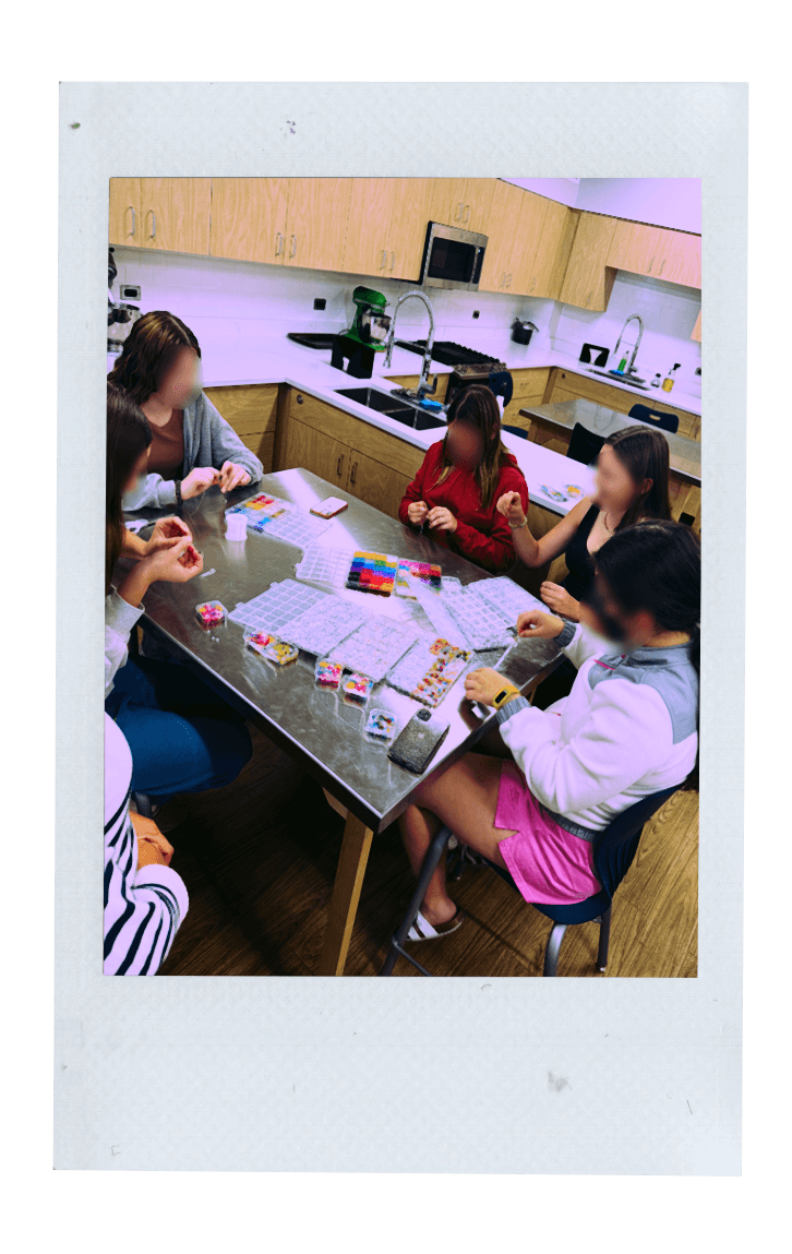 Fujifilm photo of tween girls making a friendship bracelet