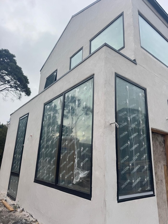 A photo of a two-storey house showing the wall outside using hempcrete blocks