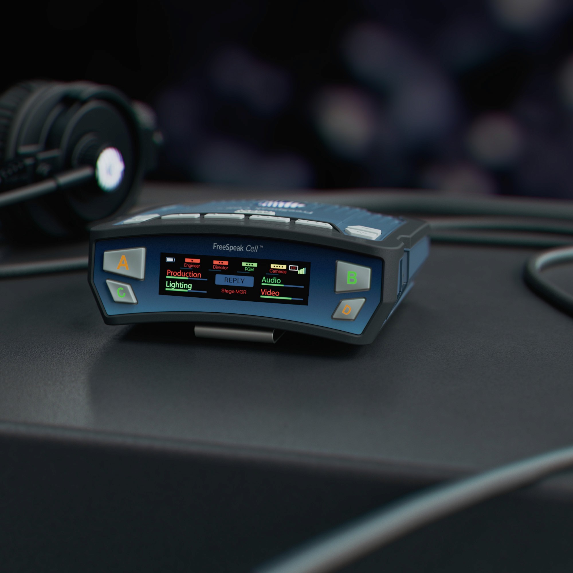 FreeSpeak Cell cellular beltpack on a professional production desk with headset.