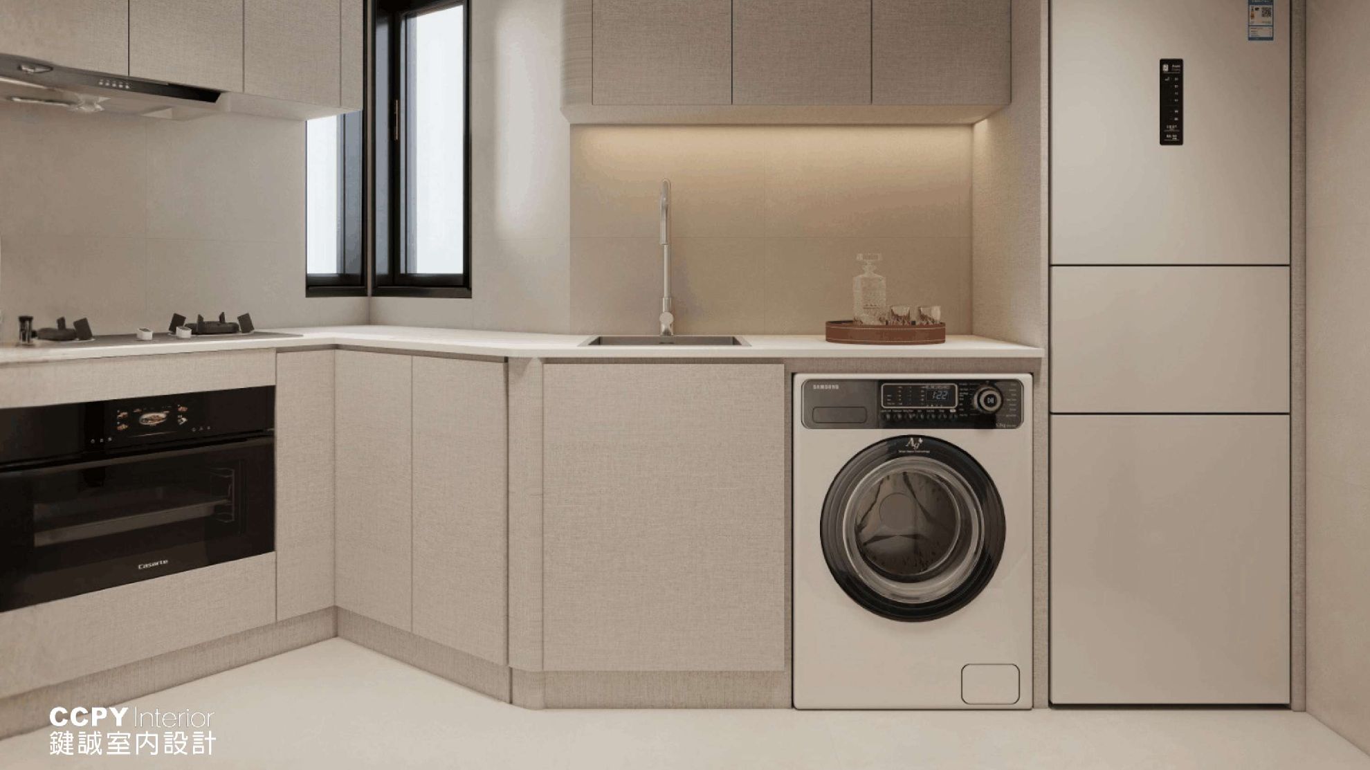 Blending utility with elegance, the kitchen area integrates a front-loading washer and minimalist cabinetry to ensure a clutter-free environment for daily household tasks.