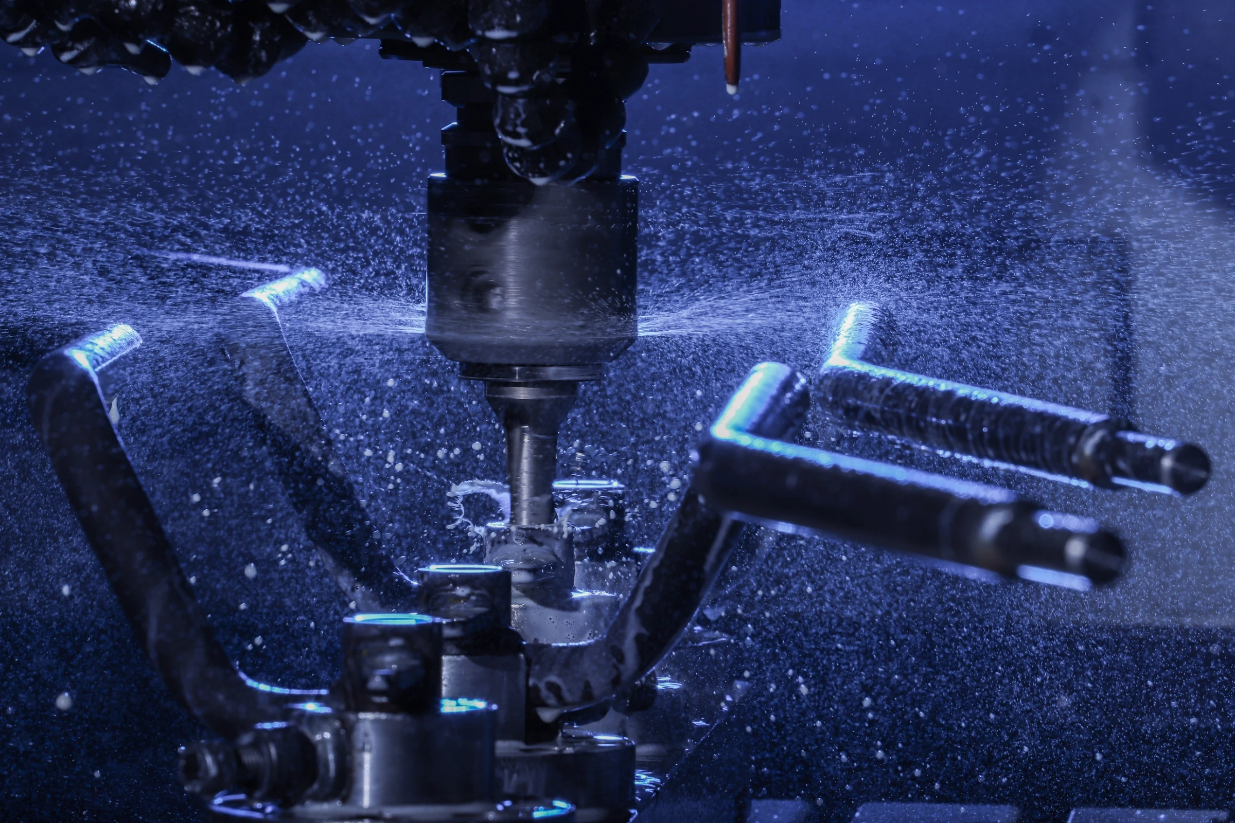 Wrzeciono obrabiarki CNC podczas precyzyjnego wiercenia z chłodzeniem.