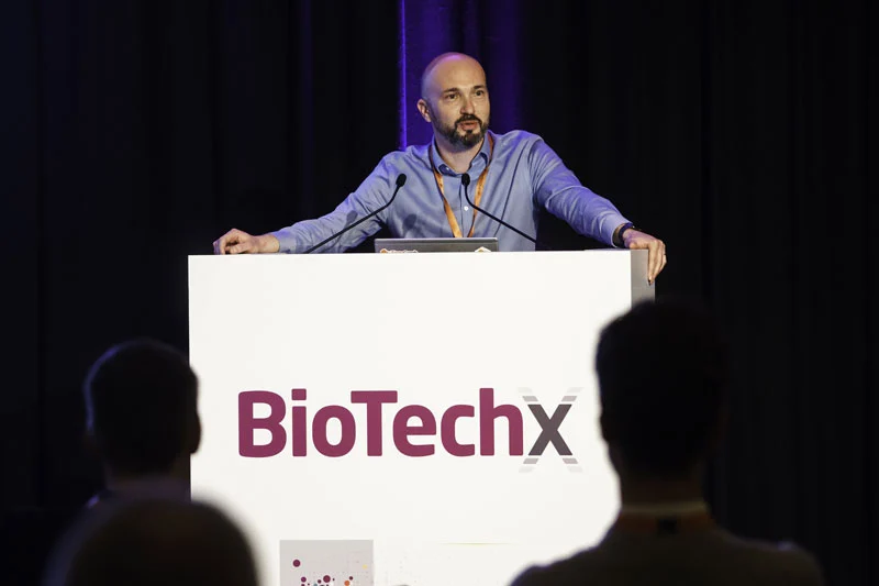 Photo of a man standing at a podium at BioTechX