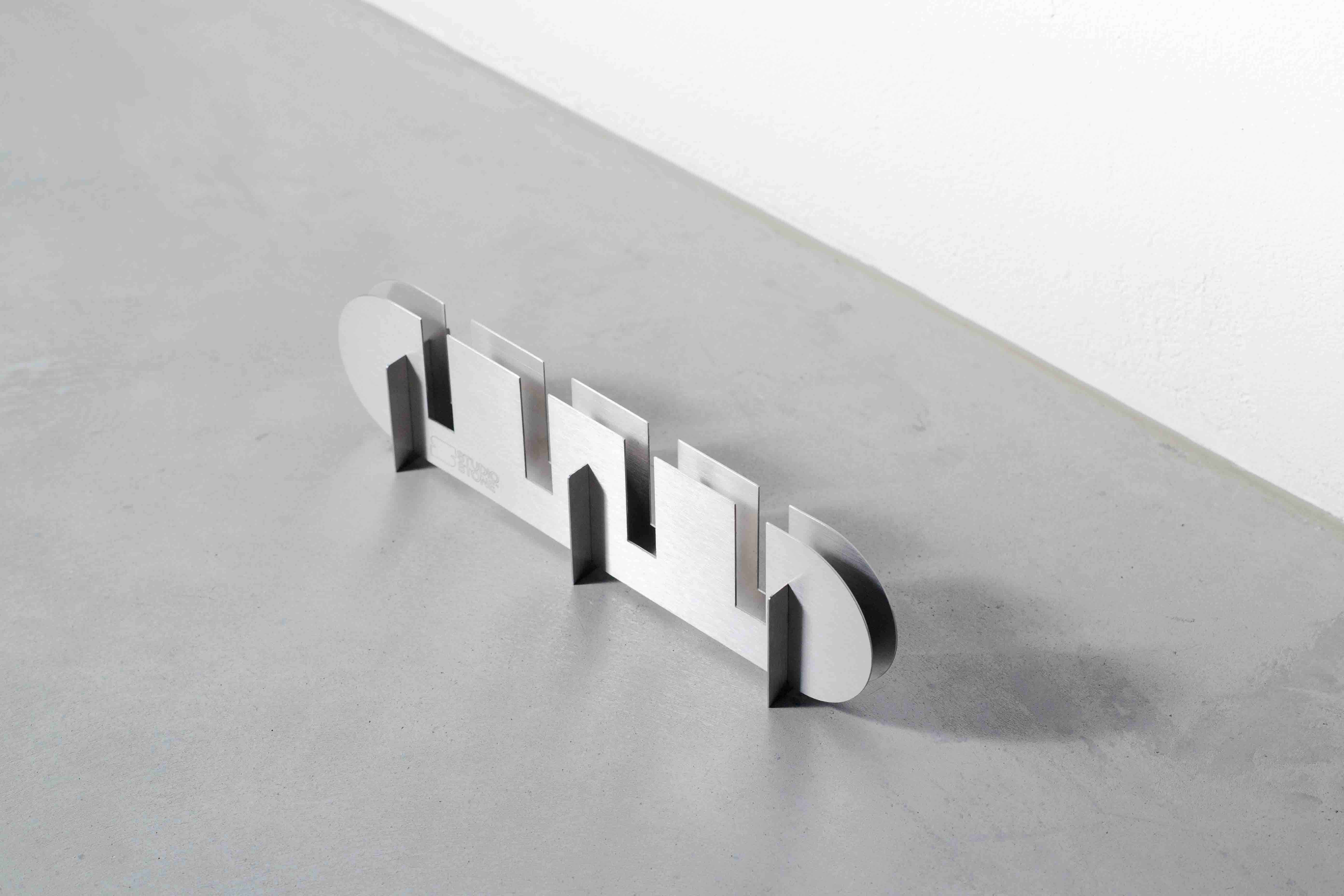 sideview of a metal candle holder on a concrete floor