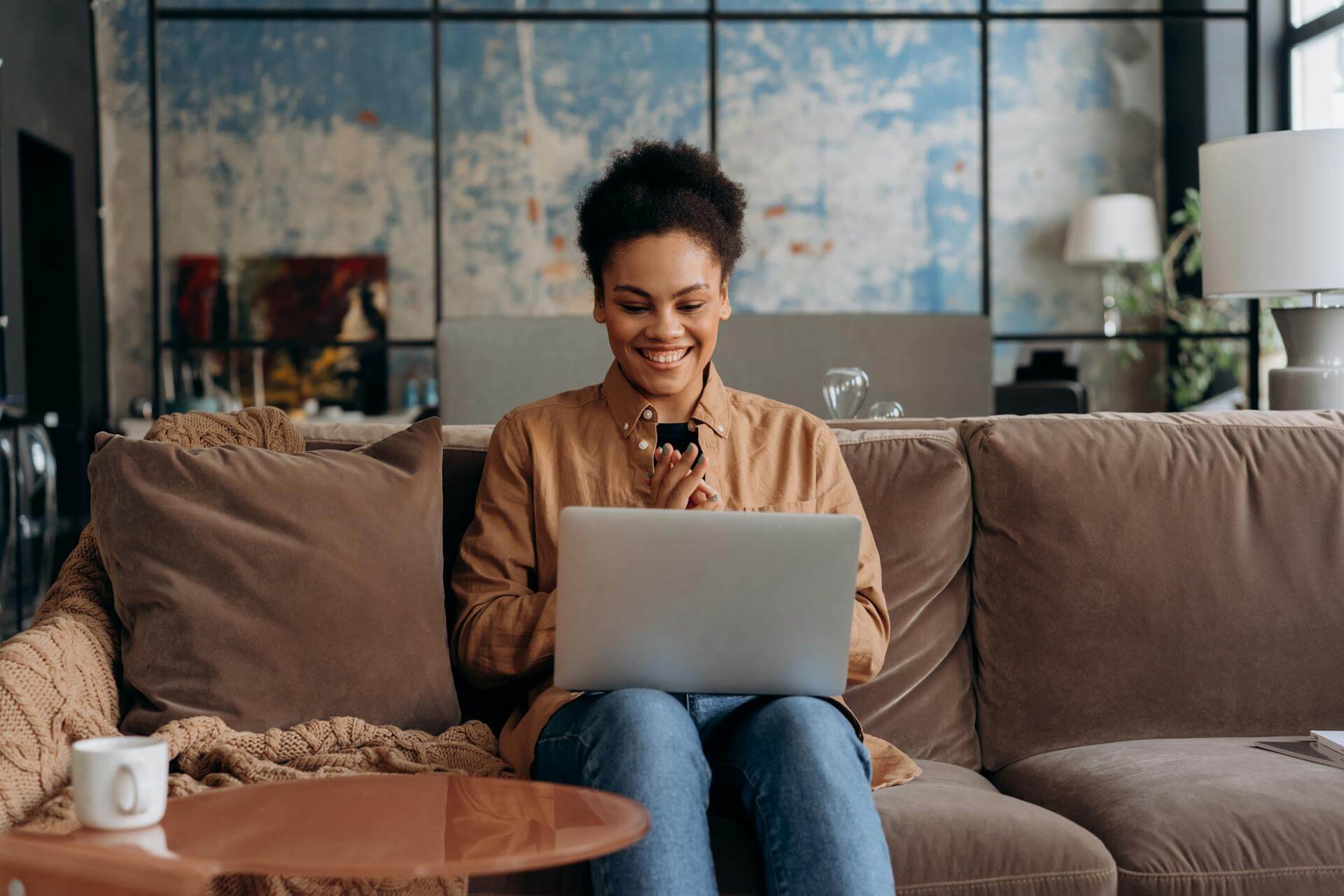 a women using her laptop and smiling