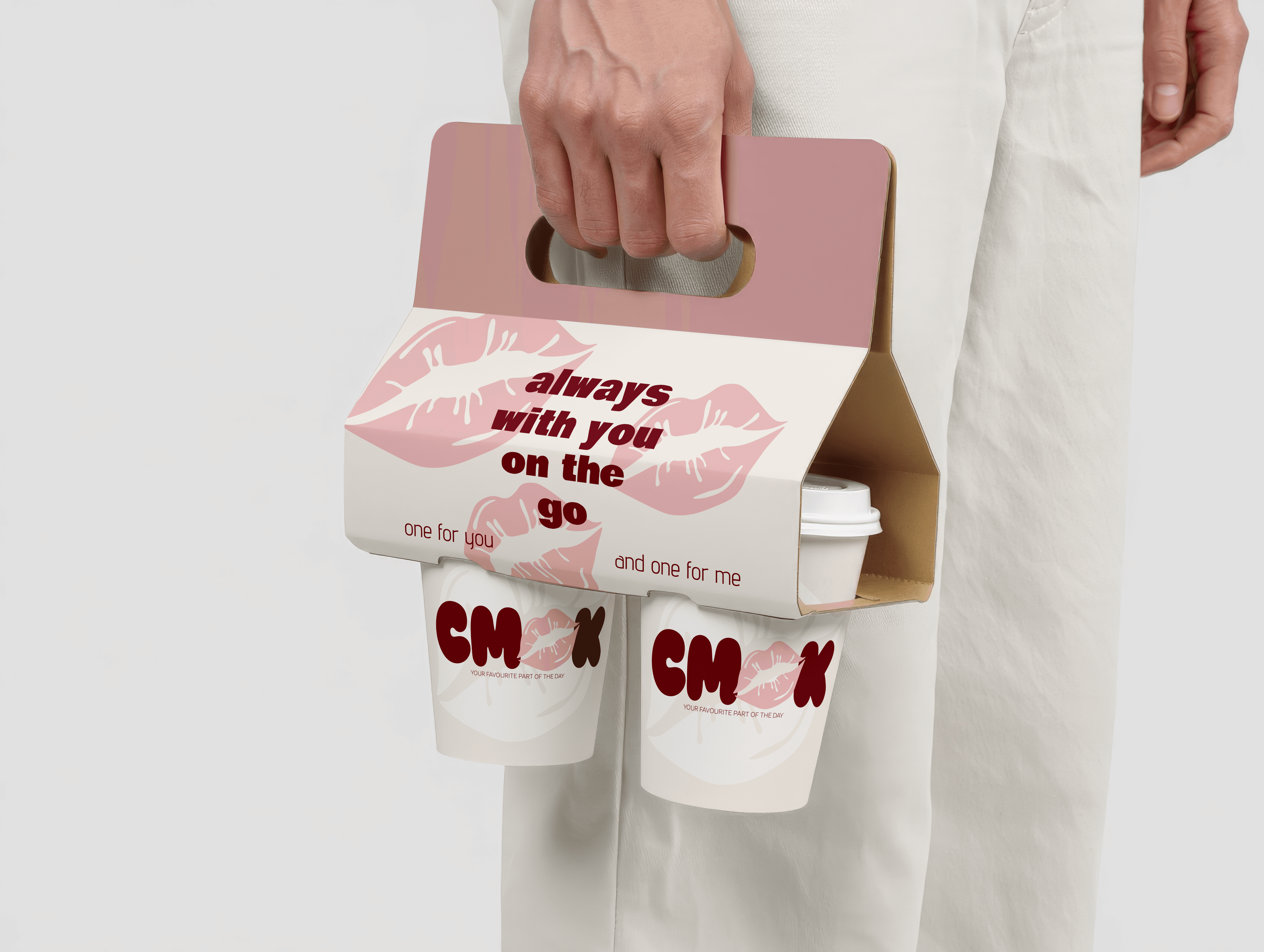 Pink CMOK coffee carrier with the slogan "always with you on the go".