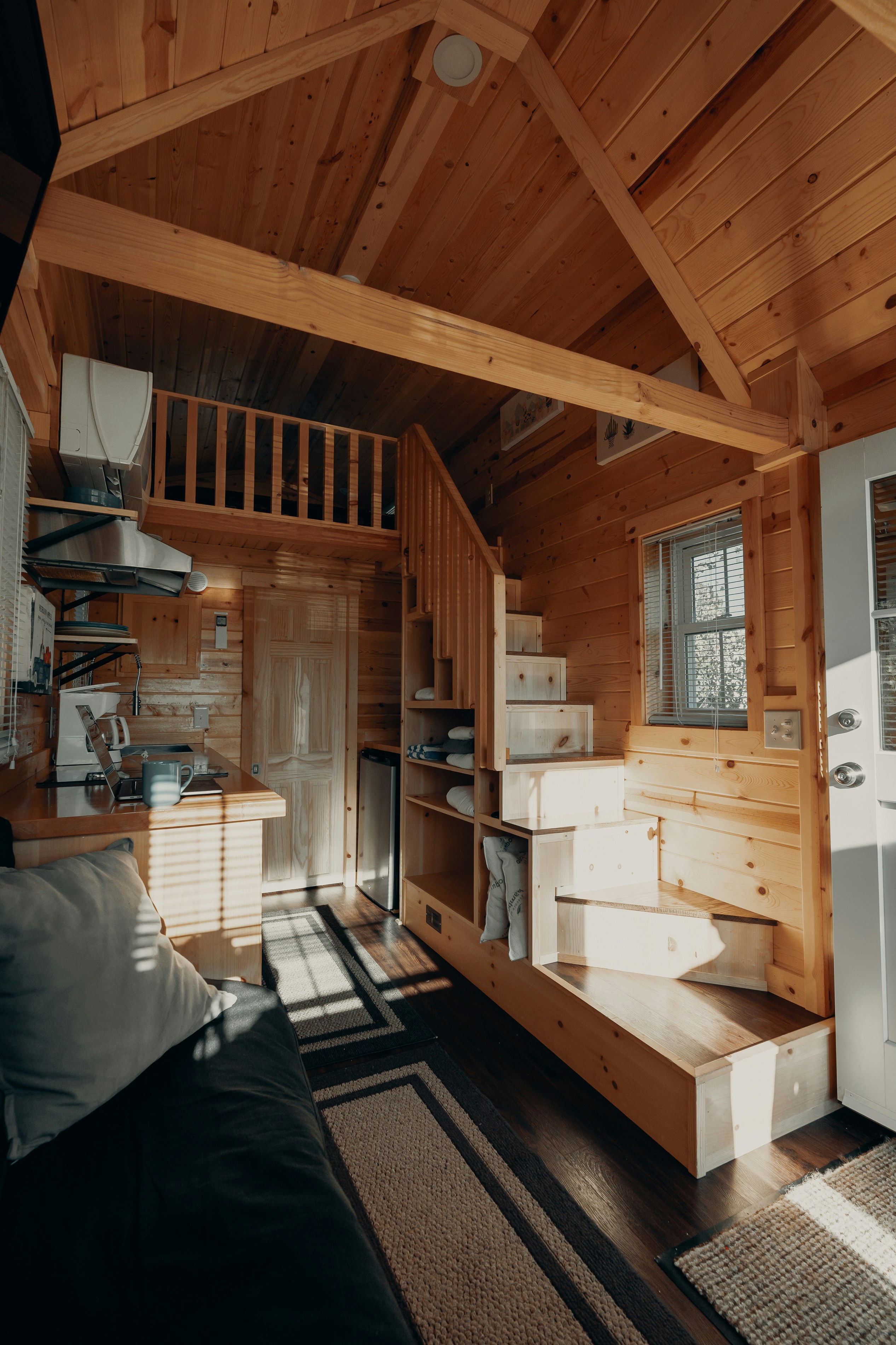 Tiny House Interior showcasing wooden stairs and ceiling