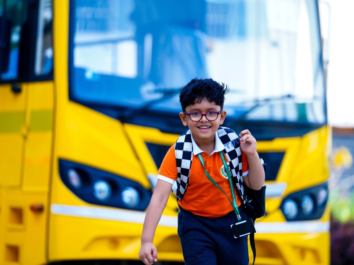 National Centre for Excellence – best CBSE school in Kodihalli – student in uniform boarding the school bus for safe transport