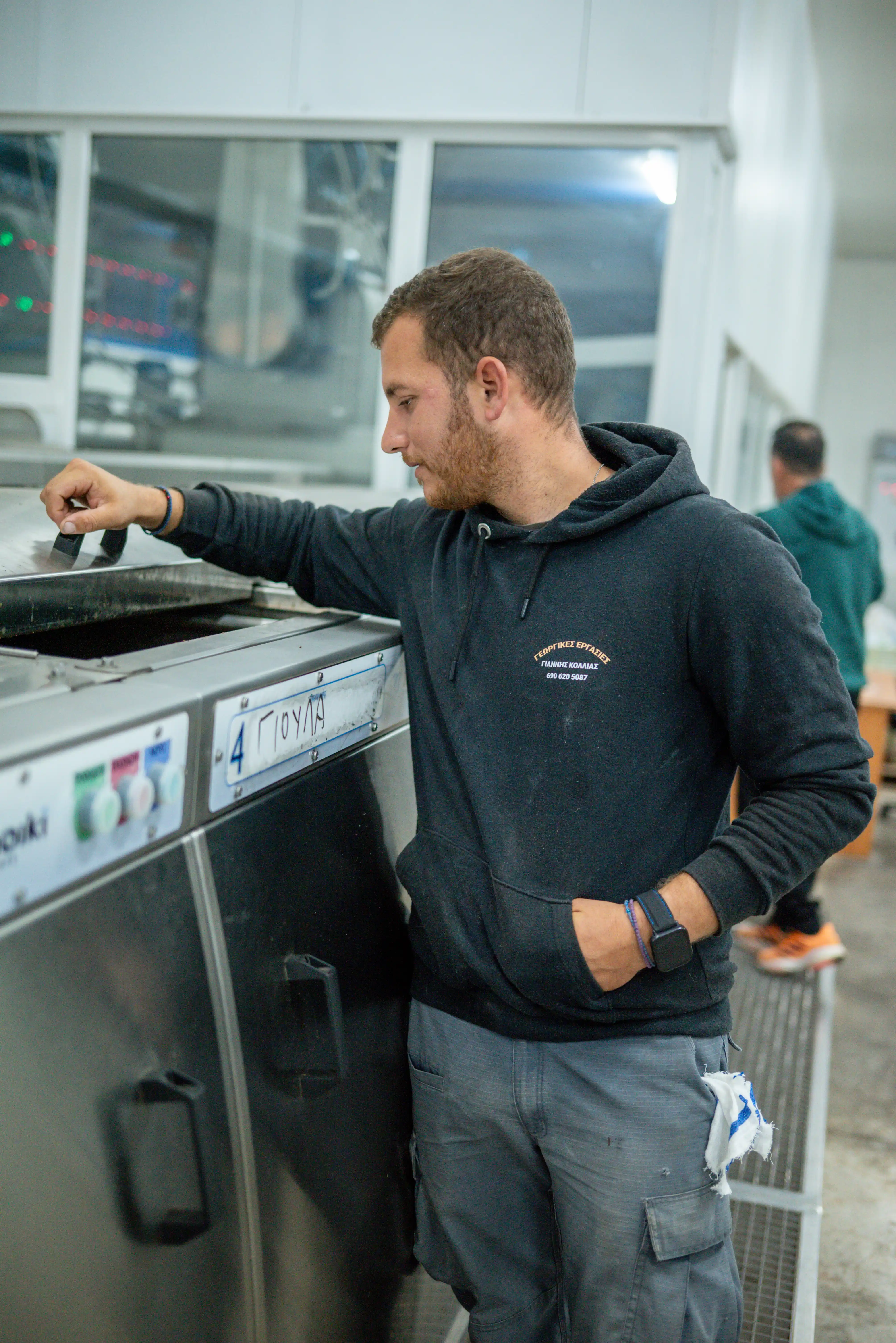 Skilled staff at Fountas olive oil mill in Filiatra, Messenia, monitoring the production process of premium extra virgin olive oil.